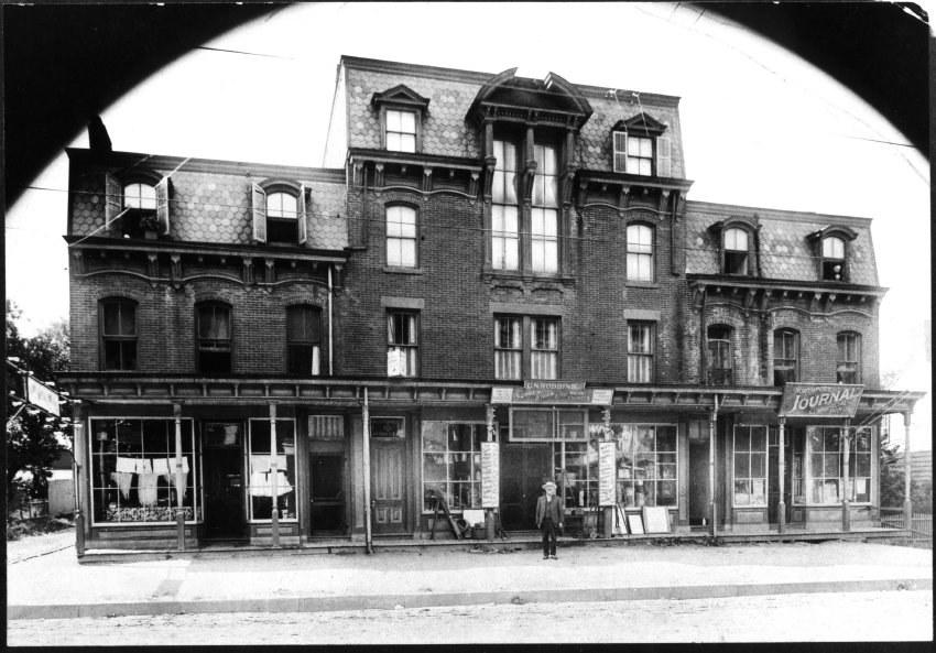 154-166 Main Street. Now called Masonic Temple. Benjamin T. Robbins, builder, stands in front. Store of Ulysses N. Robbins, (his son) Plumbing and Heating, is in center bay. Offices of Northport Journal, also owned by B. T. Robbins. Photo courtesy of Northport Historical Society.