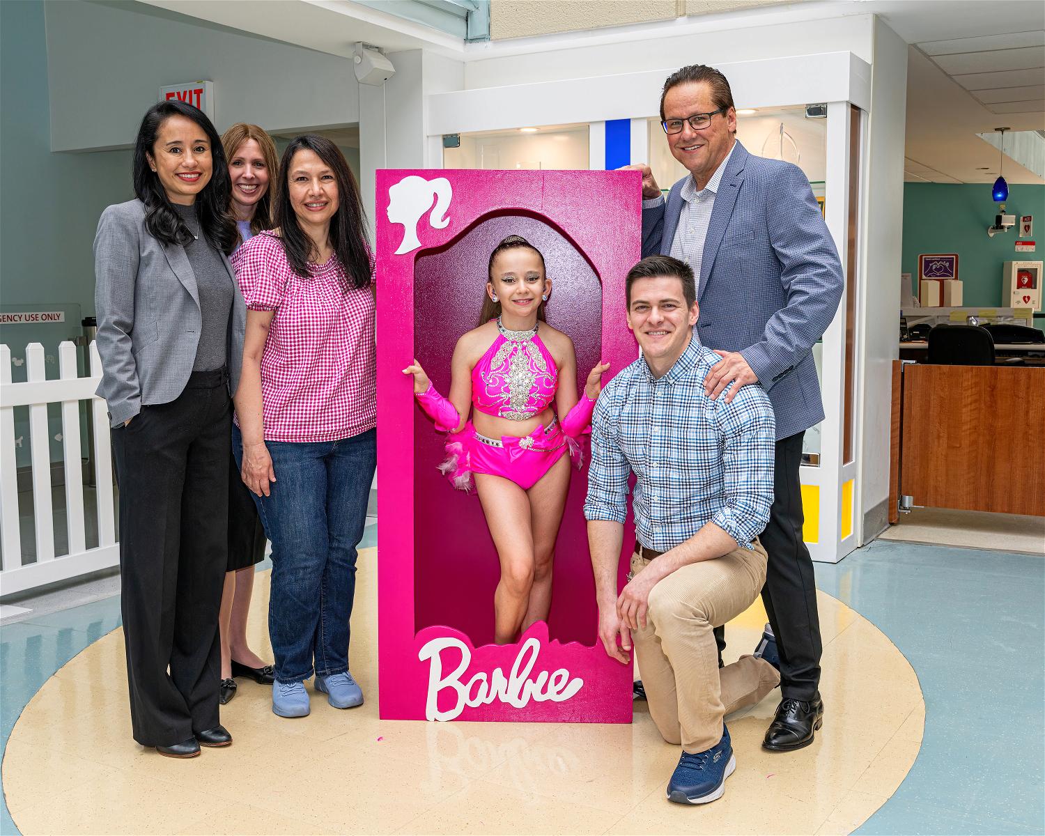 Kidney transplant recipient and 11-year-old Commack resident Emily Alanko with her parents and Cohen Children’s Medical Center doctors. Her older brother (kneeling), a pediatric doctor himself, was Alanko’s kidney donor.