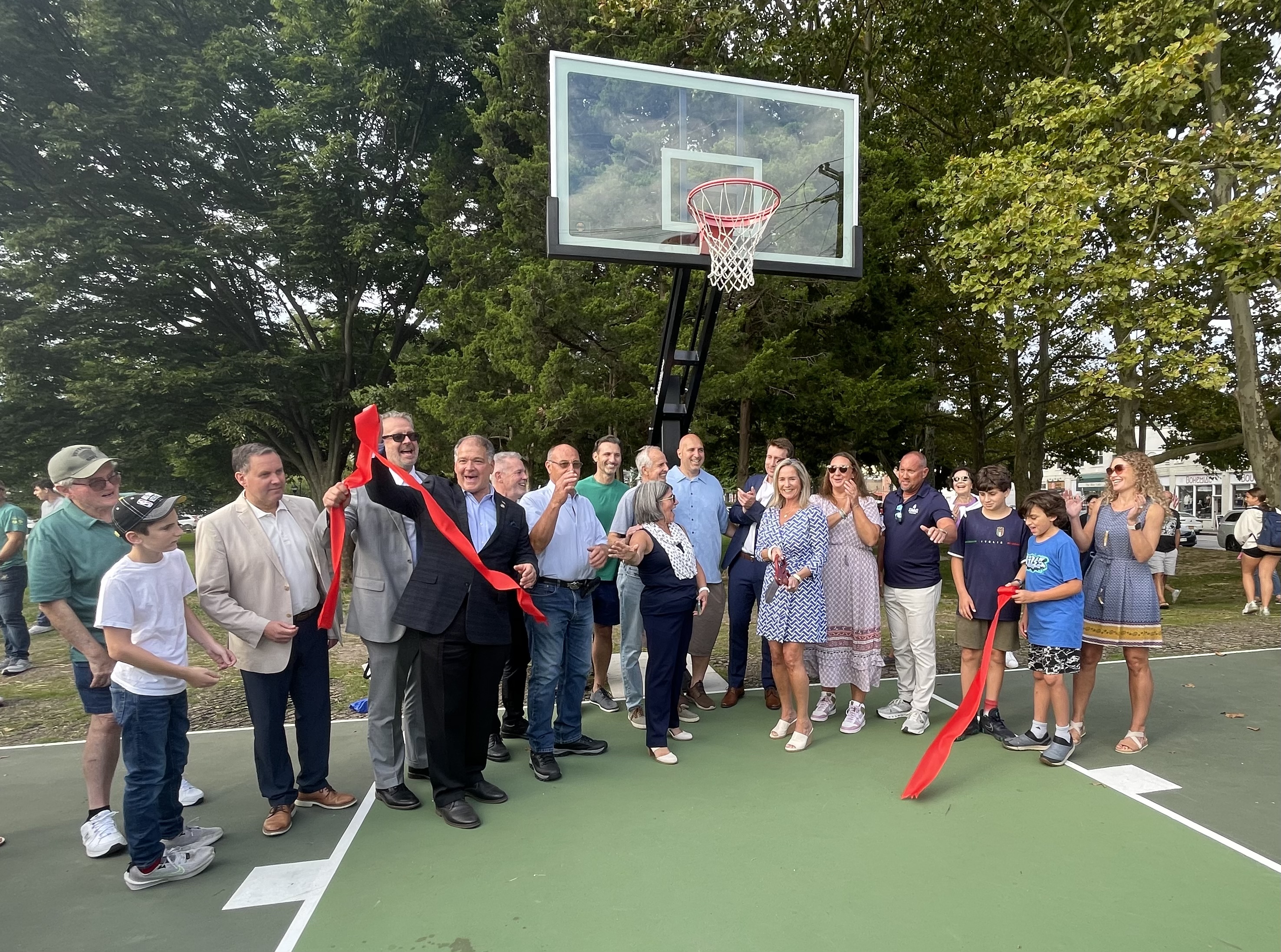 Northport Village Mayor Donna Koch and Sally Kohn (center, foreground) with, in back, John Kennedy, Doug Trani, Chris Wiebke, Meghan Dolan and Dave Weber, plus other local officials, at the September 20 John Kennedy Court ribbon cutting. 