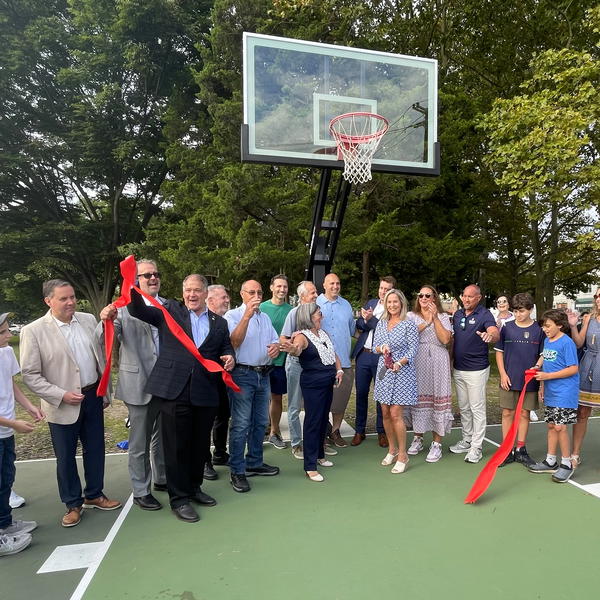 Northport Village Mayor Donna Koch and Sally Kohn (center, foreground) with, in back, John Kennedy, Doug Trani, Chris Wiebke, Meghan Dolan and Dave Weber, plus other local officials, at the September 20 John Kennedy Court ribbon cutting. 