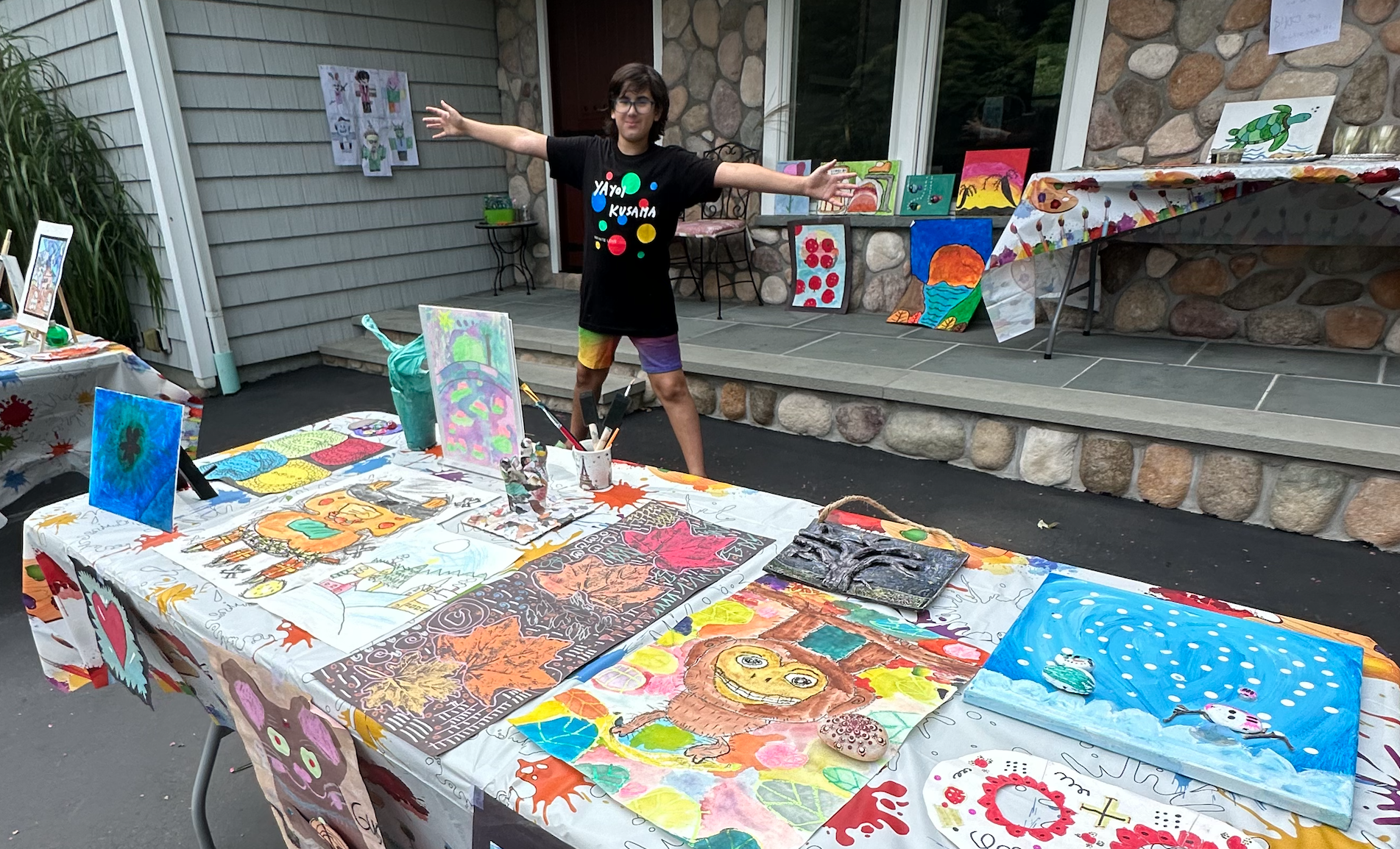 12-year-old Gus Goldstein at his at-home art gallery, a Mitzvah Project he used the profits from to get art materials into the hands of hospitalized children.