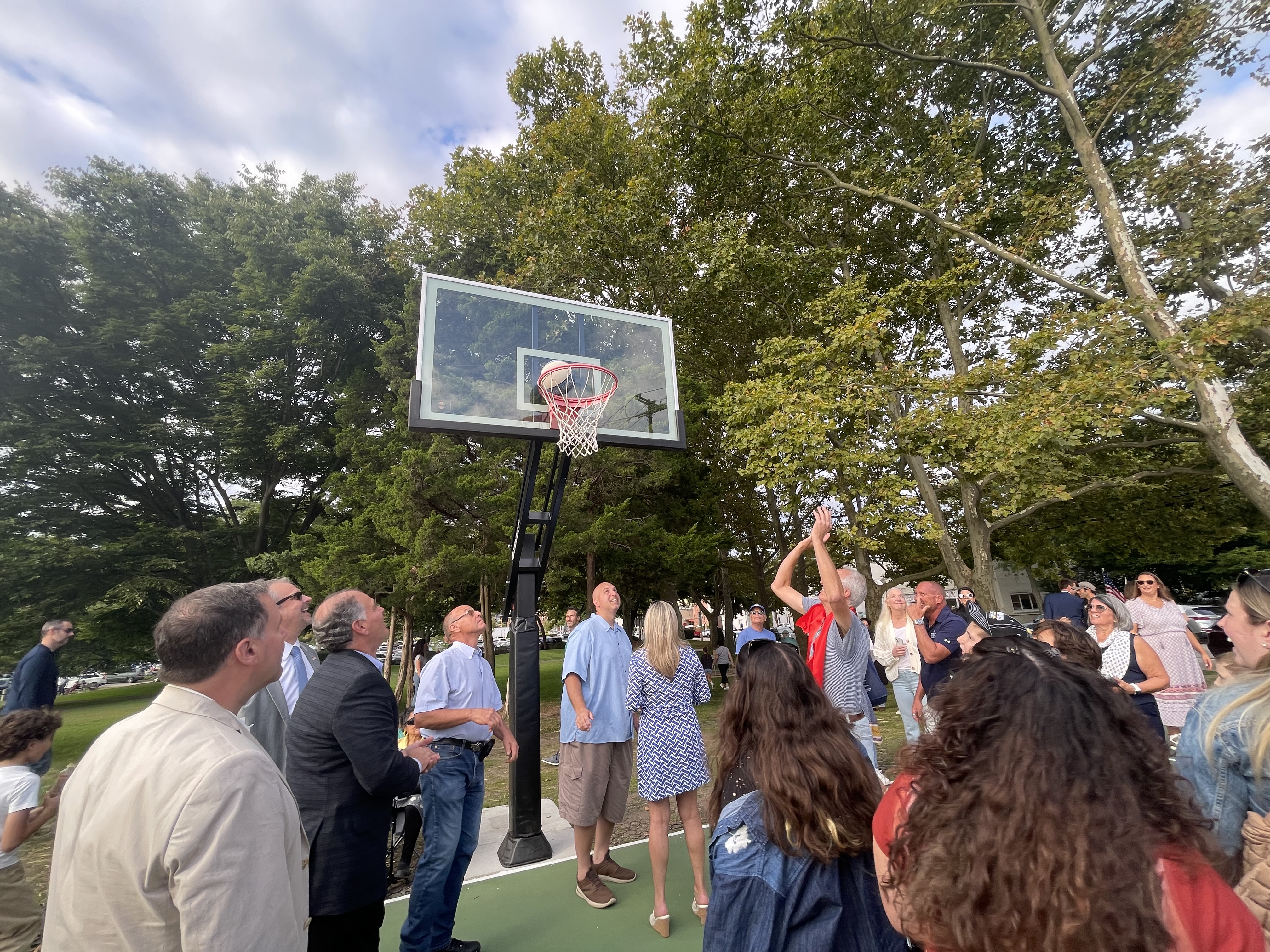 Lifetime resident John Kennedy takes a shot at the newly renovated basketball court named after him in Northport Village. 