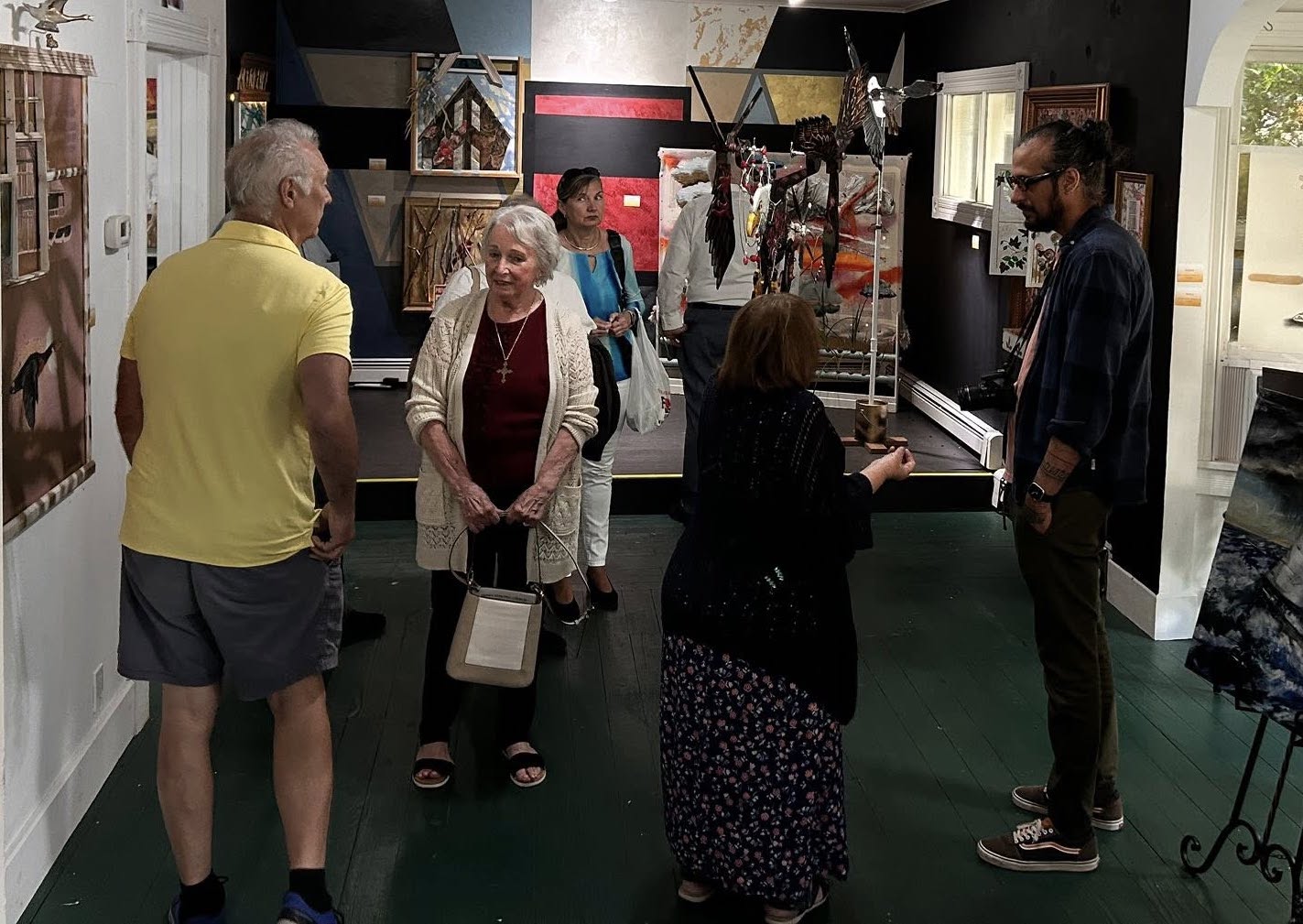 Visitors at the opening of “To Sky,” an exhibit featuring the work of artist Ricardo Labarca (right).