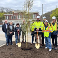 From left: Village Administrator Roland Buzard, Asharoken Deputy Mayor Pam Pierce, Northport Village Mayor Donna Koch, and Northport Trustee Rich Boziwick joined the National Grid team to plant the first of 15 trees donated to the Village by National Grid following a major pipeline replacement project.