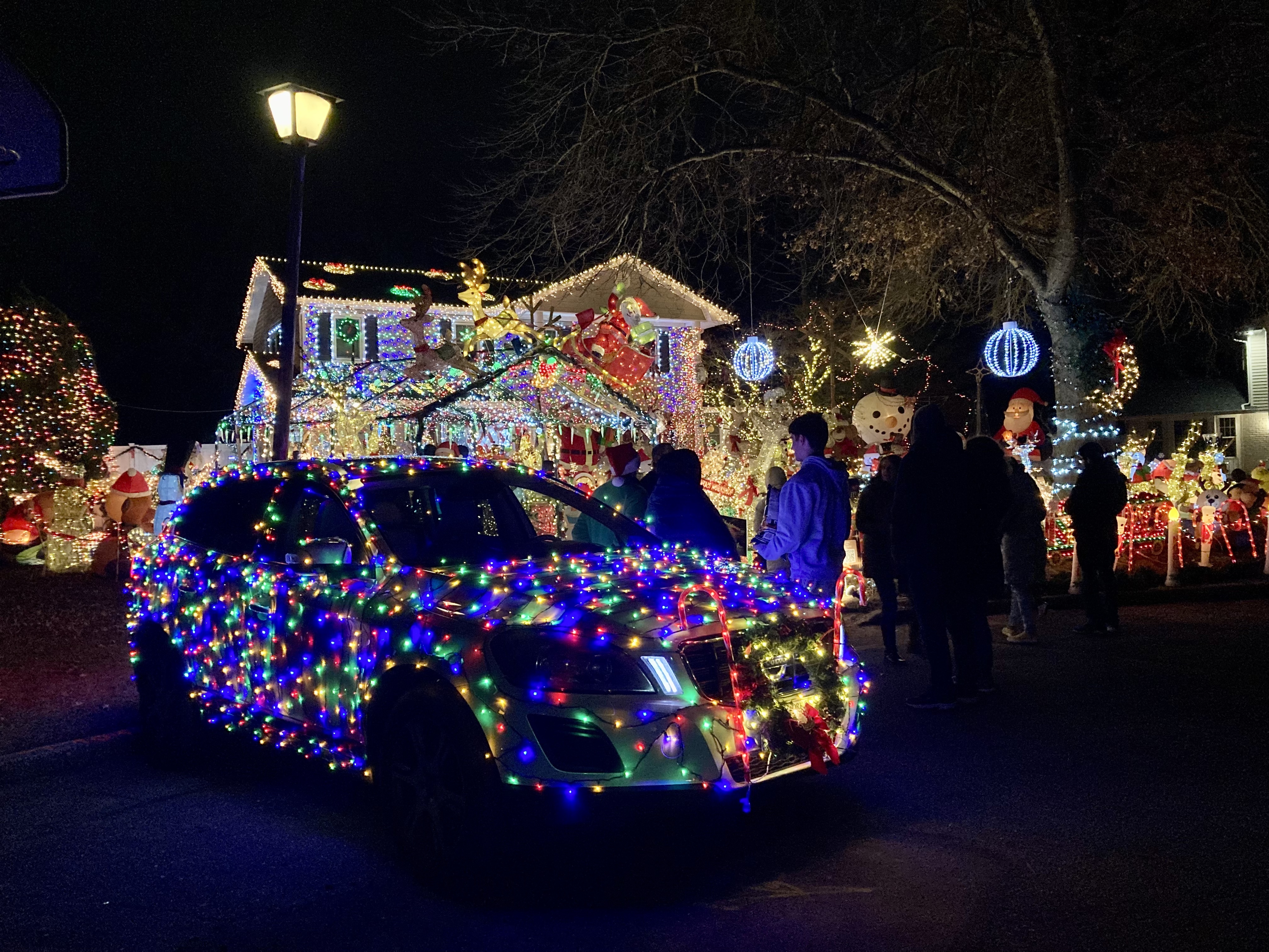 Andrew Reid (in Santa hat) greeted a steady stream of visitors to his Misfit Island holiday display this past Friday evening.