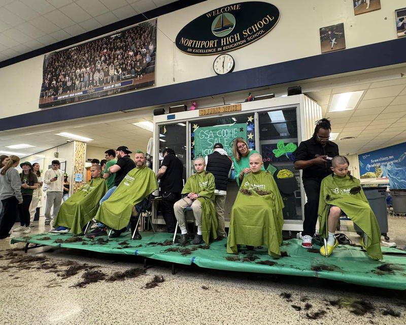 Members of the East Northport Middle School Bald Tigers team with ENMS science teacher and team captain John Braun at the March 14 St. Baldrick’s event at Northport High School. Photo courtesy Theresa Braun.  