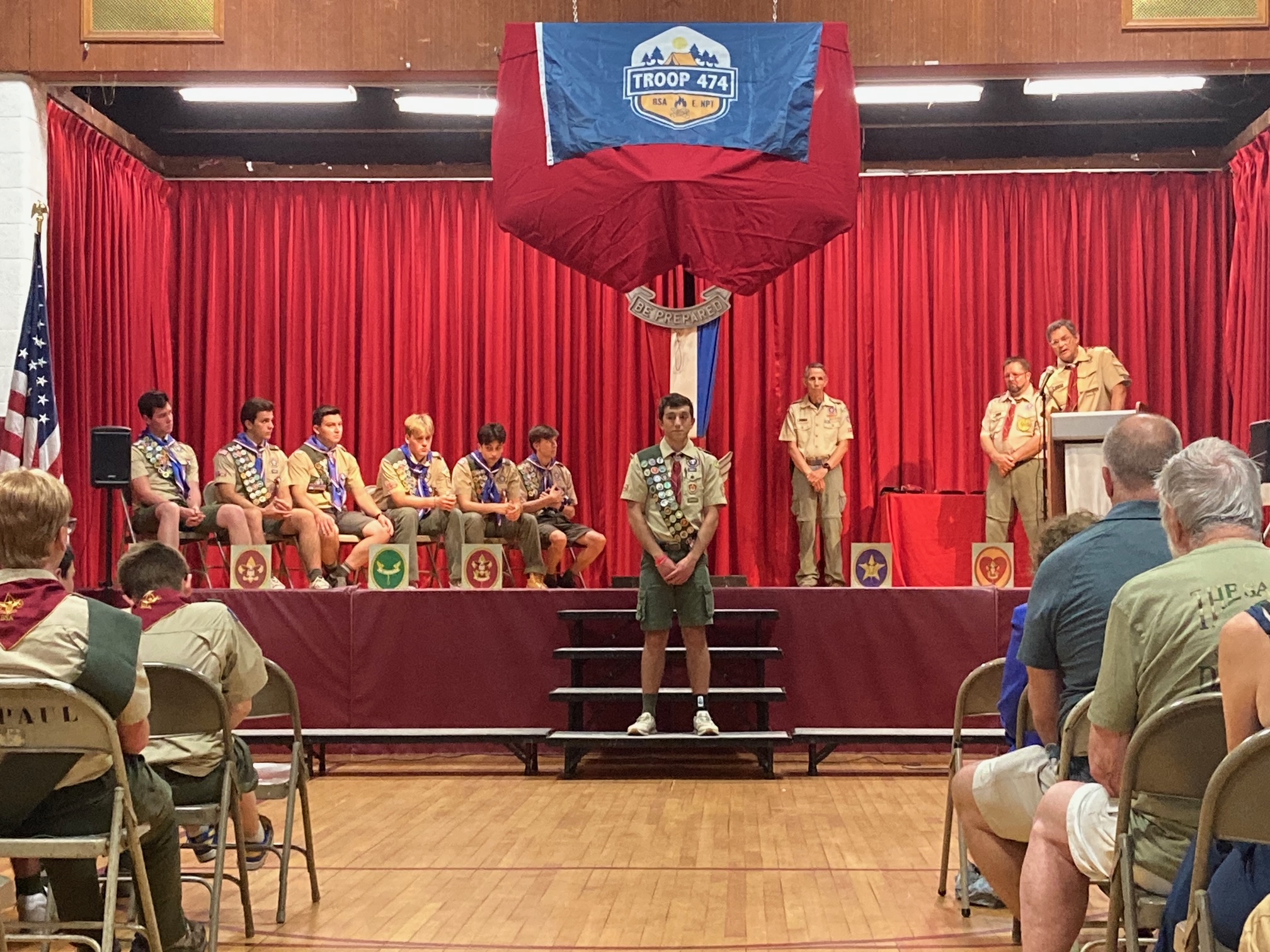 Six Northport High School students and graduates ascended to Eagle Scout, Scouts America’s highest honor. Shown in photo (seated l to r), Max Hagerman, Christopher Monda, Kyle Nock, Luc Wagner, Athan Zarkadas, and Nate Zarko. Chris Monda is at center and, shown at stage right (l to r), David Hunt, Scouting America Suffolk County Council Executive Board Chairman; Robert Thall, Troop 474 Assistant Scoutmaster; and, Mike Tambone, Troop 474 Scoutmaster.