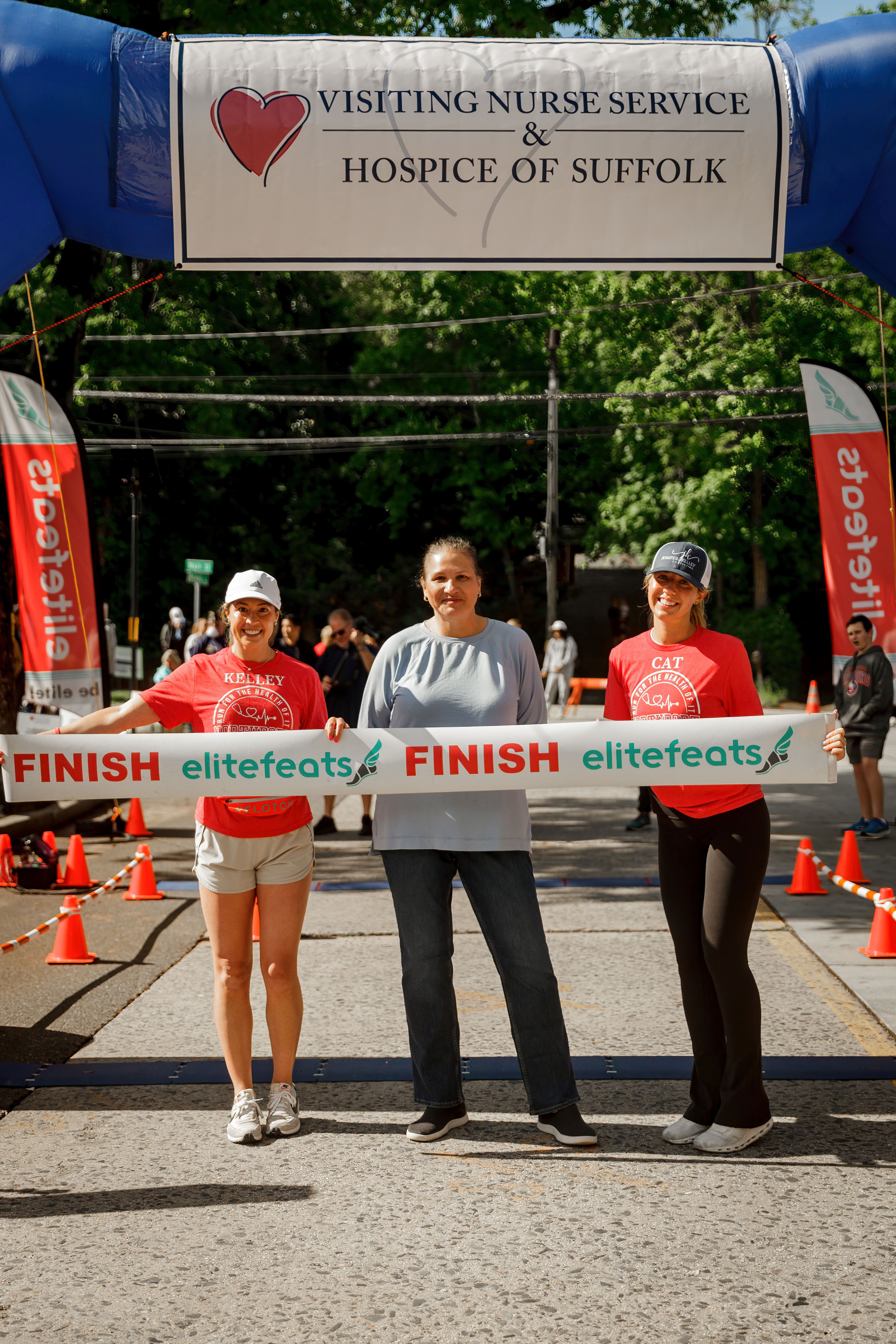 CEO Silvia Cota (center) joins race organizers Kelley Henneberry and Catherine Shanley of J&K Consulting at the finish line of the Run for the Health of It 5K.
