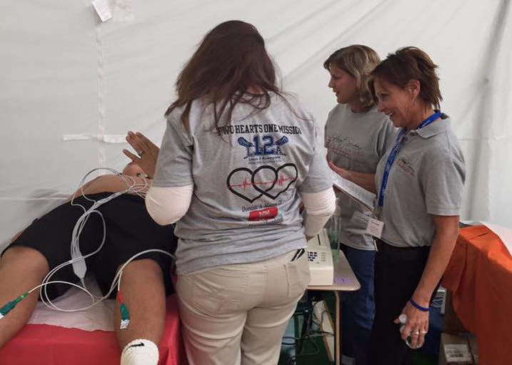 Karen Acompora (right) at a past youth heart screening event. This year’s free event will take place at Oldfield Middle School on February 1. Image via heartscreennewyork.com. 