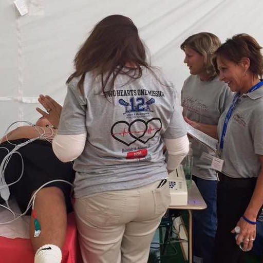 Karen Acompora (right) at a past youth heart screening event. This year’s free event will take place at Oldfield Middle School on February 1. Image via heartscreennewyork.com. 