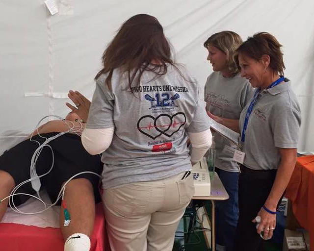 Karen Acompora (right) at a past youth heart screening event. This year’s free event will take place at Oldfield Middle School on February 1. Image via heartscreennewyork.com. 