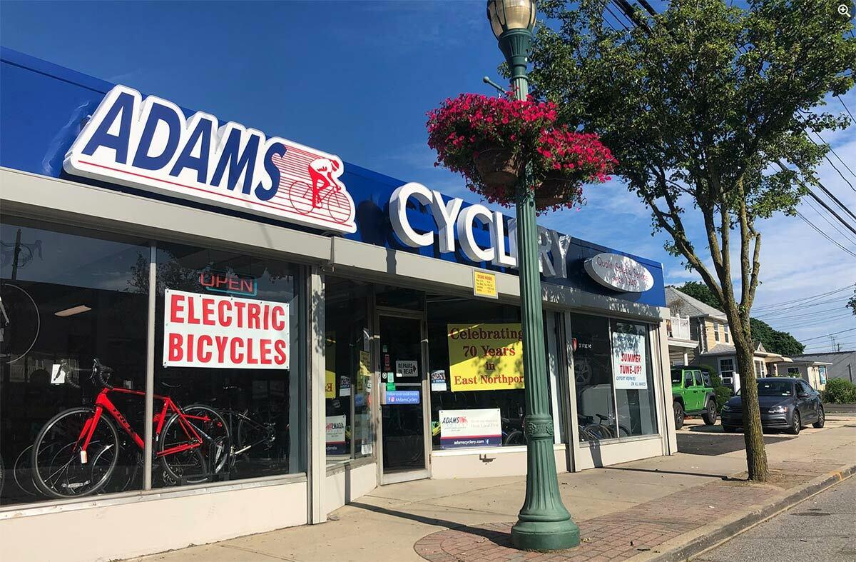 Denise and Chuck Adams of Adams Cyclery in East Northport have announced their retirement. 2019 photo via Facebook.