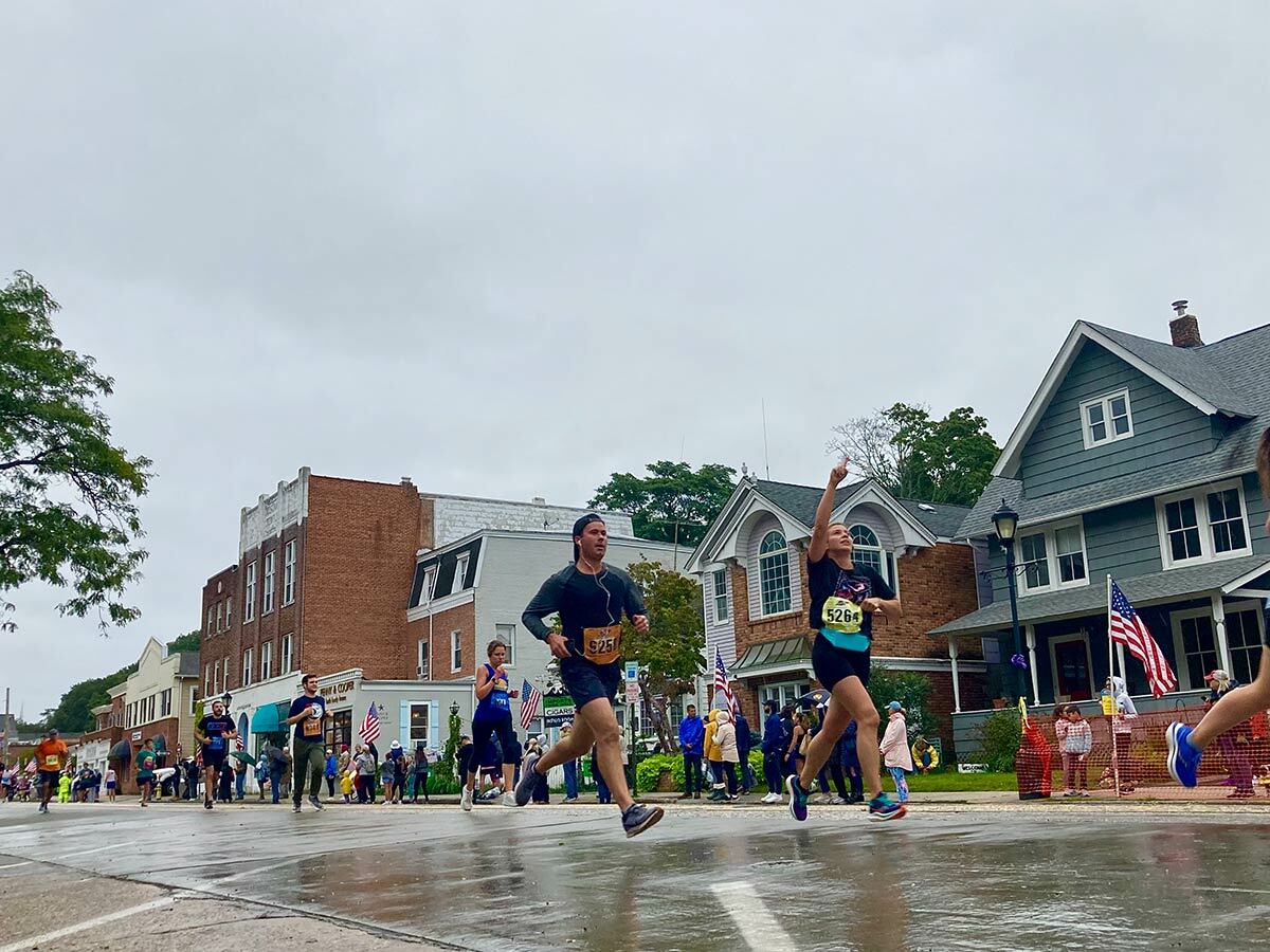 Renee Psarras of Commack feeling grateful as she approaches the finish line of the Great Cow Harbor 10K.