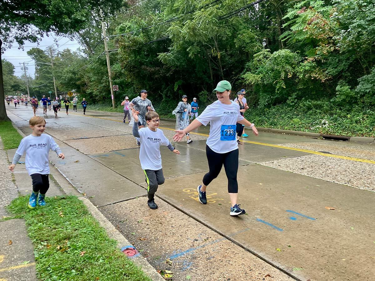 These proud sons greeting their mom on the Main Street near Laurel Avenue, just minutes away from the finish line.