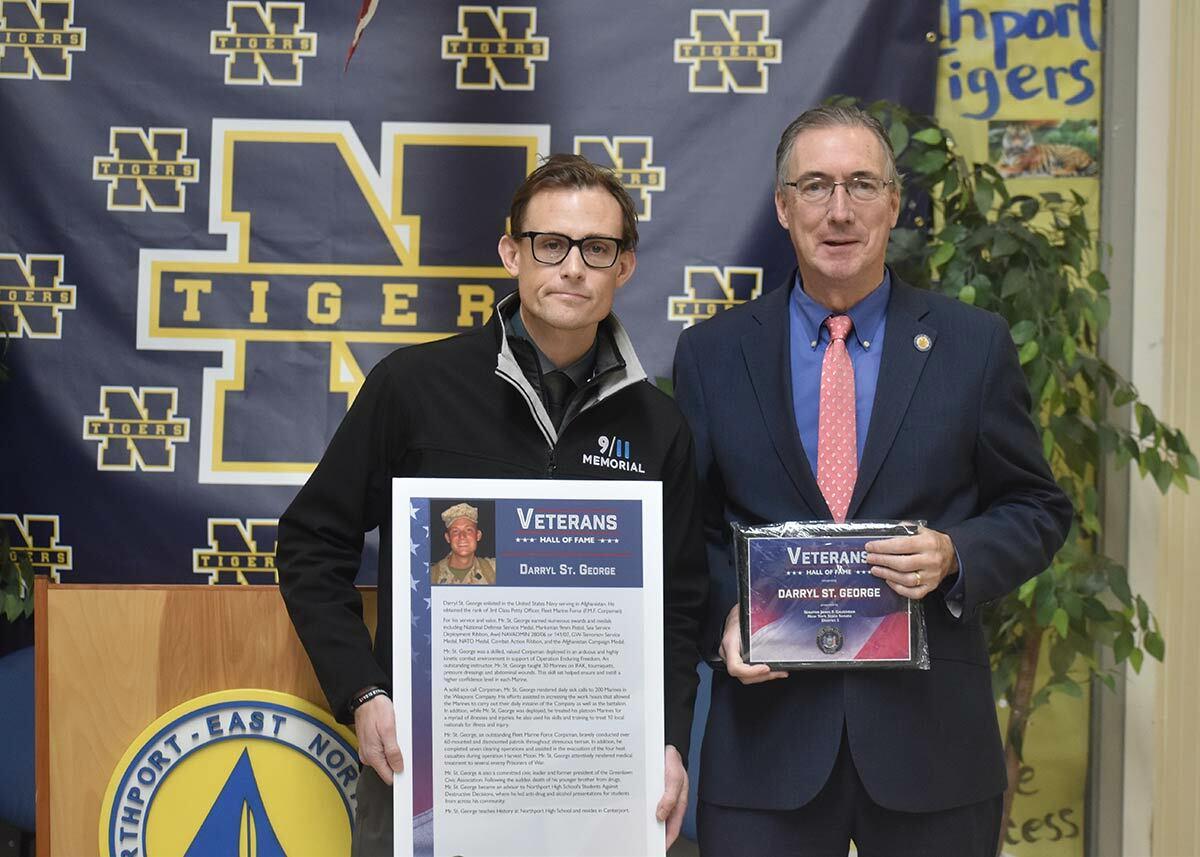 Senator James Gaughran (right) presents Northport High School social studies teacher and veteran Darryl St. George with his Veteran’s Hall of Fame plaque.