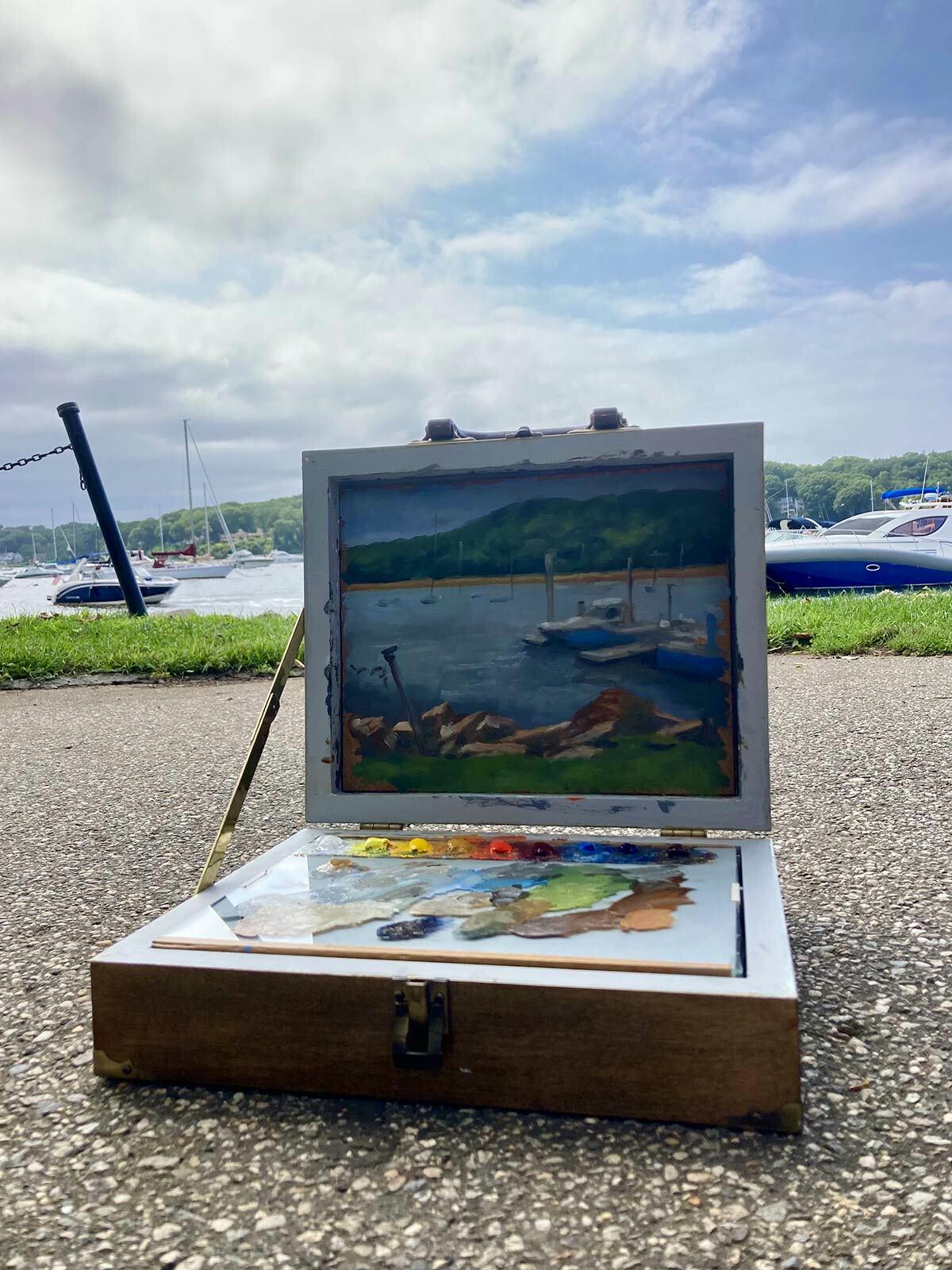 Firefly managing partner Drigo Morin’s portable art box with his painting-in-progress of the harbor.