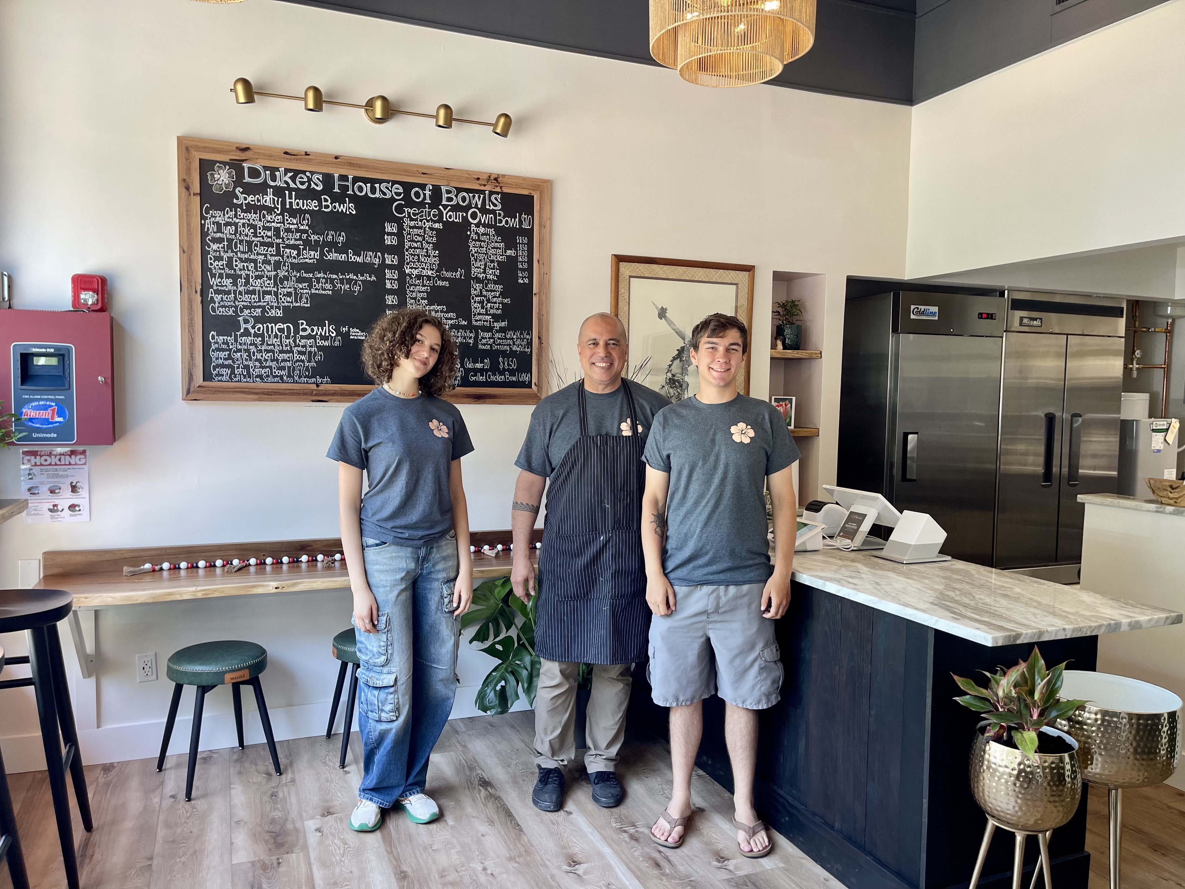 Duke’s House of Bowls owner Gene DeFreitas (center) announced the opening of his Woodbine Avenue eatery last week and is already gaining popularity for unique takeout options in Northport Village. 