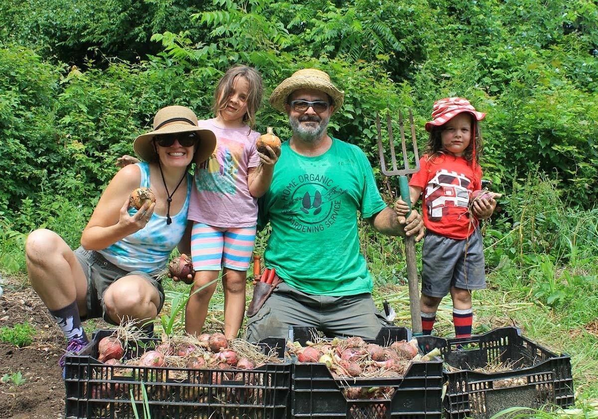 Northport Village resident and local gardener Dylan Licopoli with his wife Jesse and their children Leona and Valentine at the Robert Kubecka Memorial Organic Garden, near the corner of Greenlawn and Dunlop Roads.