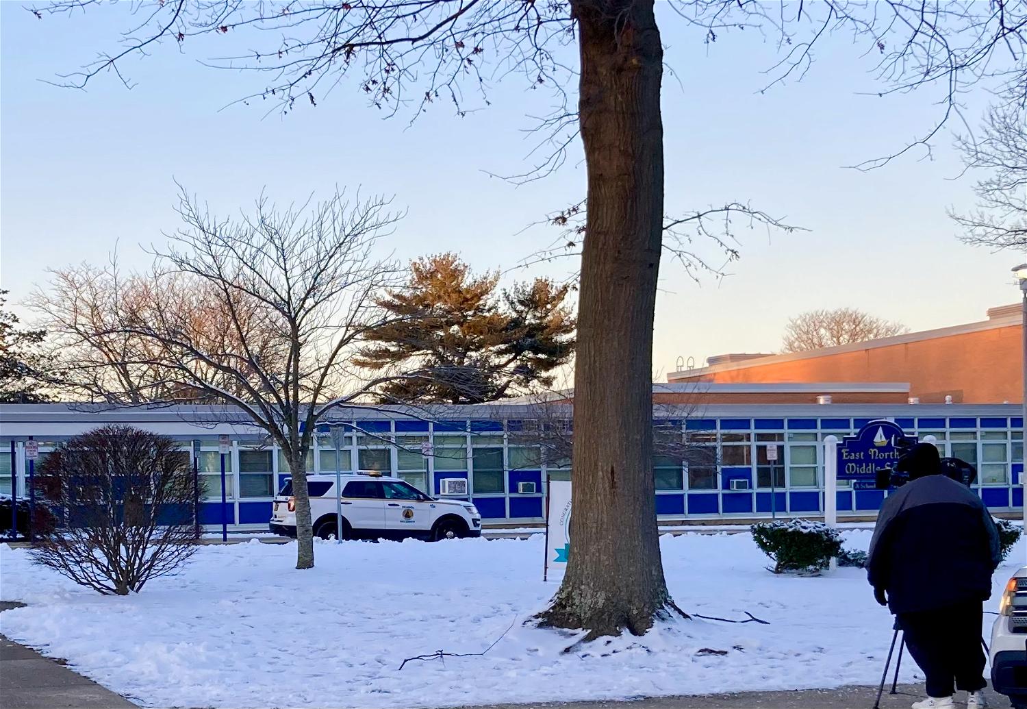 A News12 cameraman sets up outside East Northport Middle School where, earlier in the day, a student was removed from class for making a threat against the school on SnapChat.  