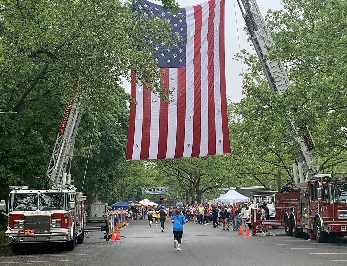 Runners approach the finish line of the Cpl. Christopher G. Scherer “I Did the Grid” Memorial 4-mile Run/Walk this past Saturday, May 28. Photo credit Joanna Adinolfi.