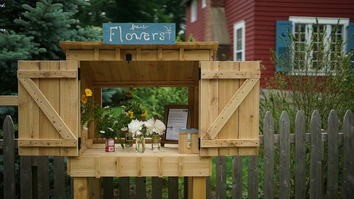 The Little Free Flower Stand on Norwood Avenue has been delighting the community with “beauty and joy.” Photo by Tim Anderson