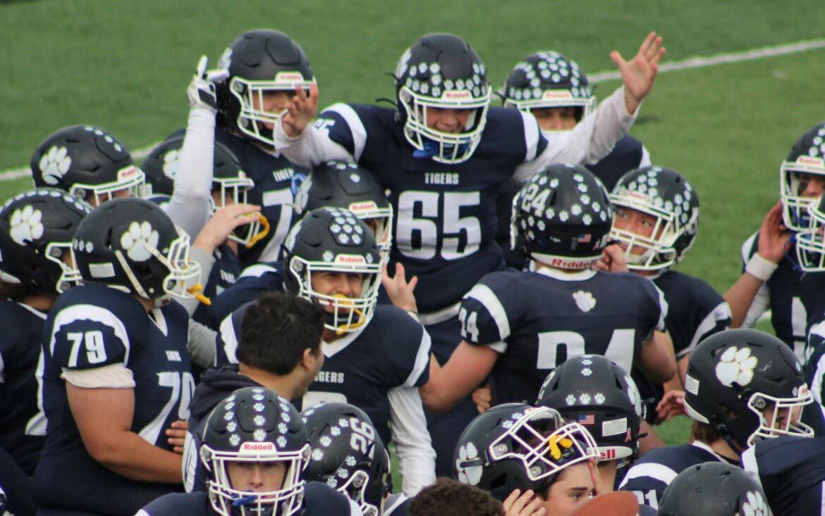 Long snapper Jason Mohlmann gets carried off the field by his teammates after a walk-off field goal that claimed a 17-14 victory against the Smithtown Bulls. Photo by Laura Holden.