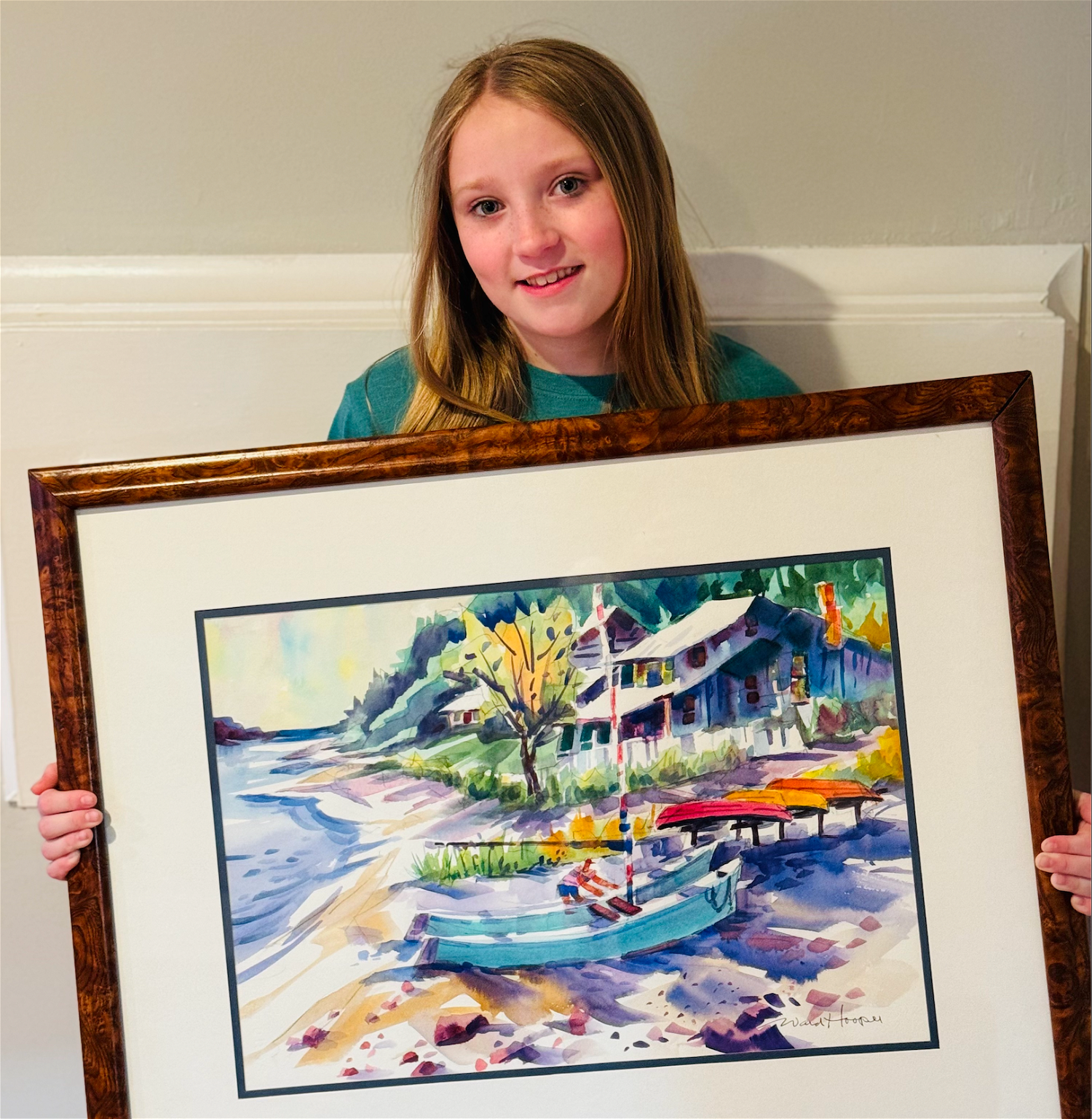 Bridget Gorman with the artwork selected by her family at the Ward Hooper event. Her dad, Matt, connected with the painting because his grandfather used to sail around Asharoken in a catamaran.