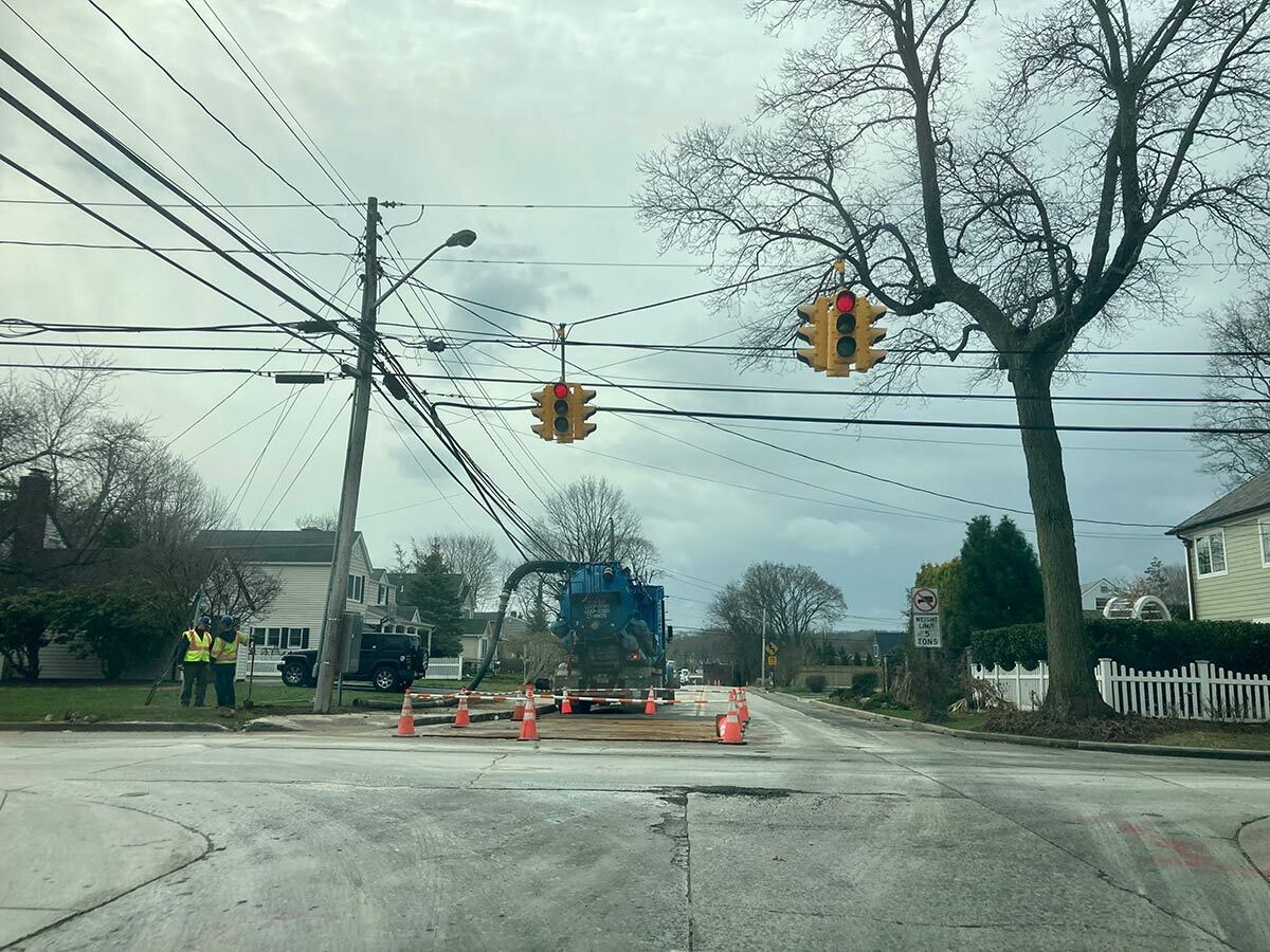 Work continued yesterday on Church Street at Scudder Avenue, the site of an oil leak in Northport Village on March 30. An estimate of the amount of fluid spilled has not yet been determined.