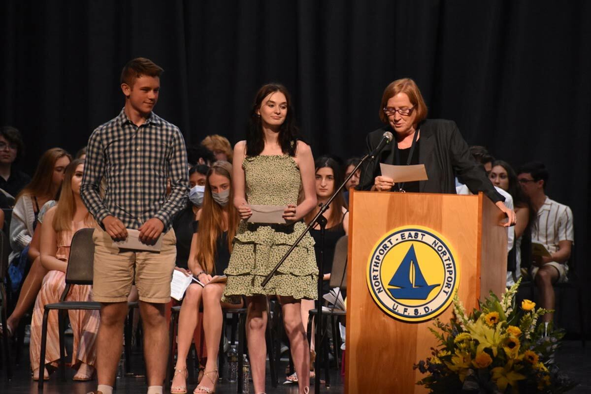 Assistant Superintendent of Human Resources Irene McLaughlin presents the Happy School Bus Scholarships to Ashley Dawson and Shane McGlone. Photo courtesy of the Northport-East Northport school district.