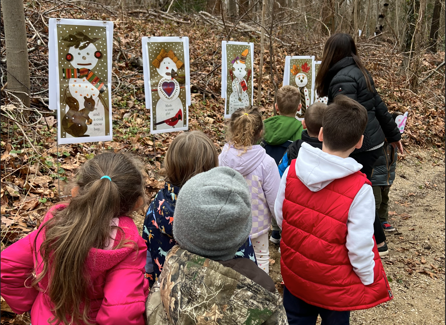 Northport Nursery students on a winter story walk along the school&#39;s hiking trail. 