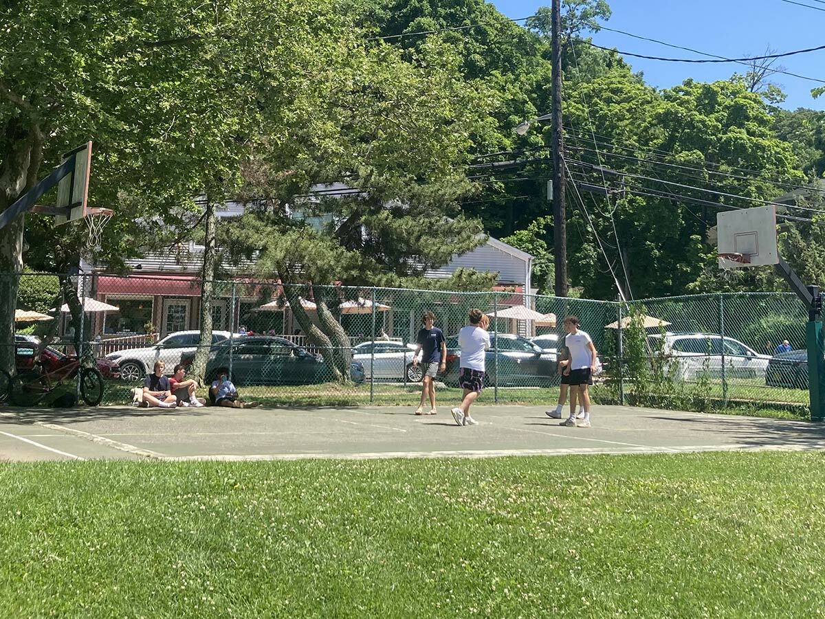 A group of teenagers plays basketball on the morning of Monday, June 20. A public hearing regarding the future of the Northport Village basketball court and its proposed revitalization is scheduled for July 12 at the Northport American Legion.