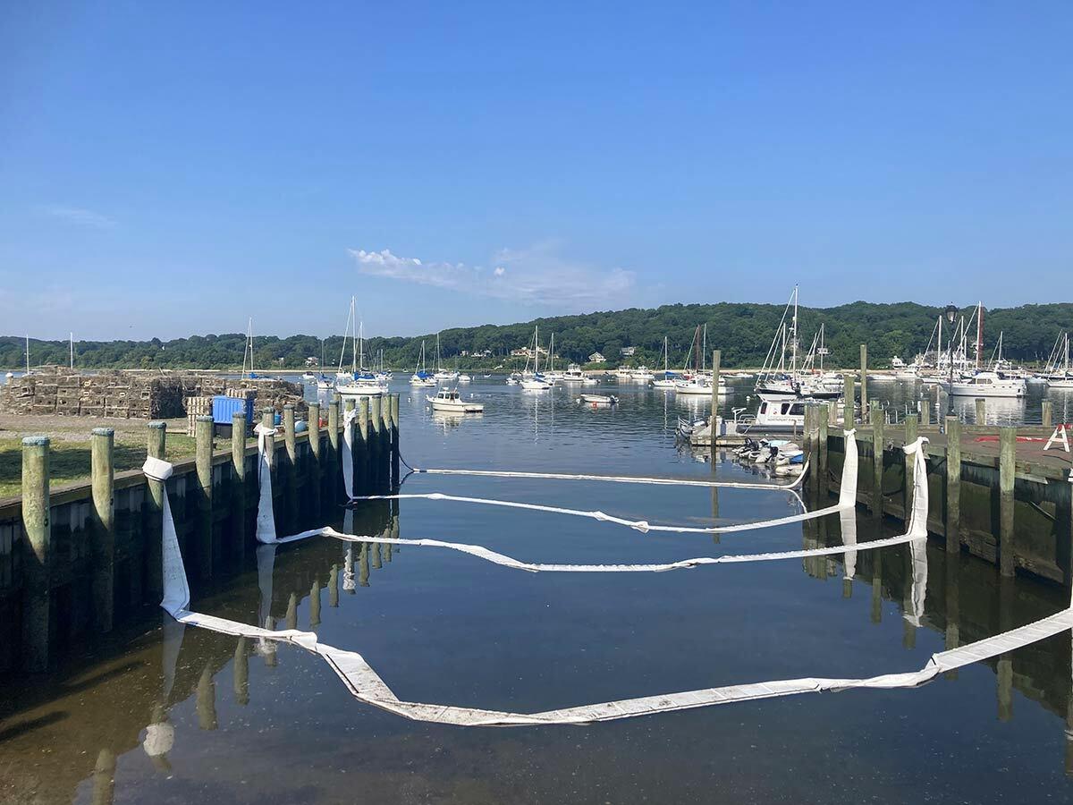 Multiple layers of protective berms have been placed in the water of Northport Harbor to capture any dielectric fluid carried downhill by Monday’s rainfall.