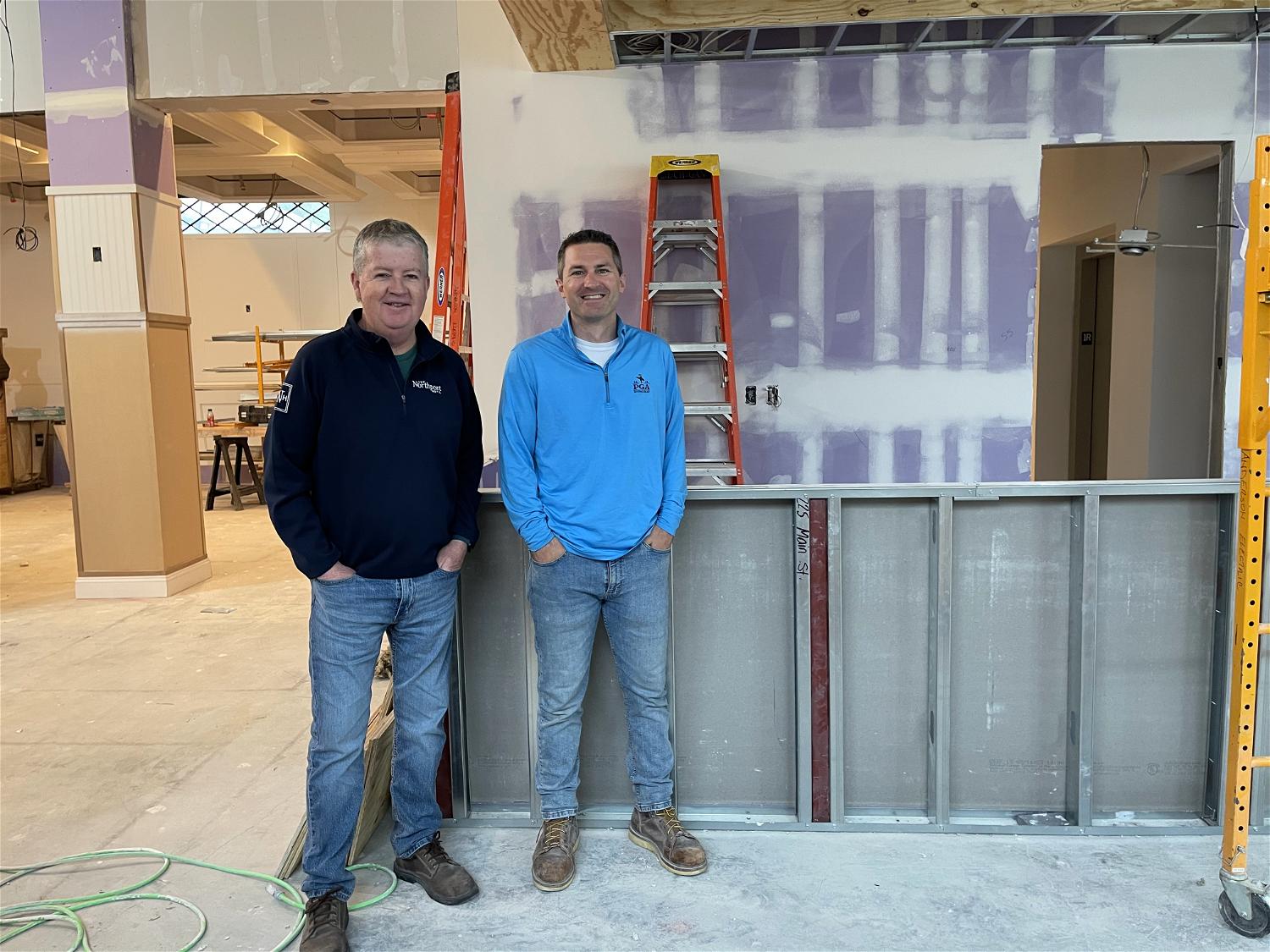 Kevin O’Neill, co-owner of the Northport Hotel, with lifelong Northporter Timothy Cocks of TC3 Construction and Consulting, at what will soon be the restaurant bar. Reservations for hotel stays beginning August 1 are now open.