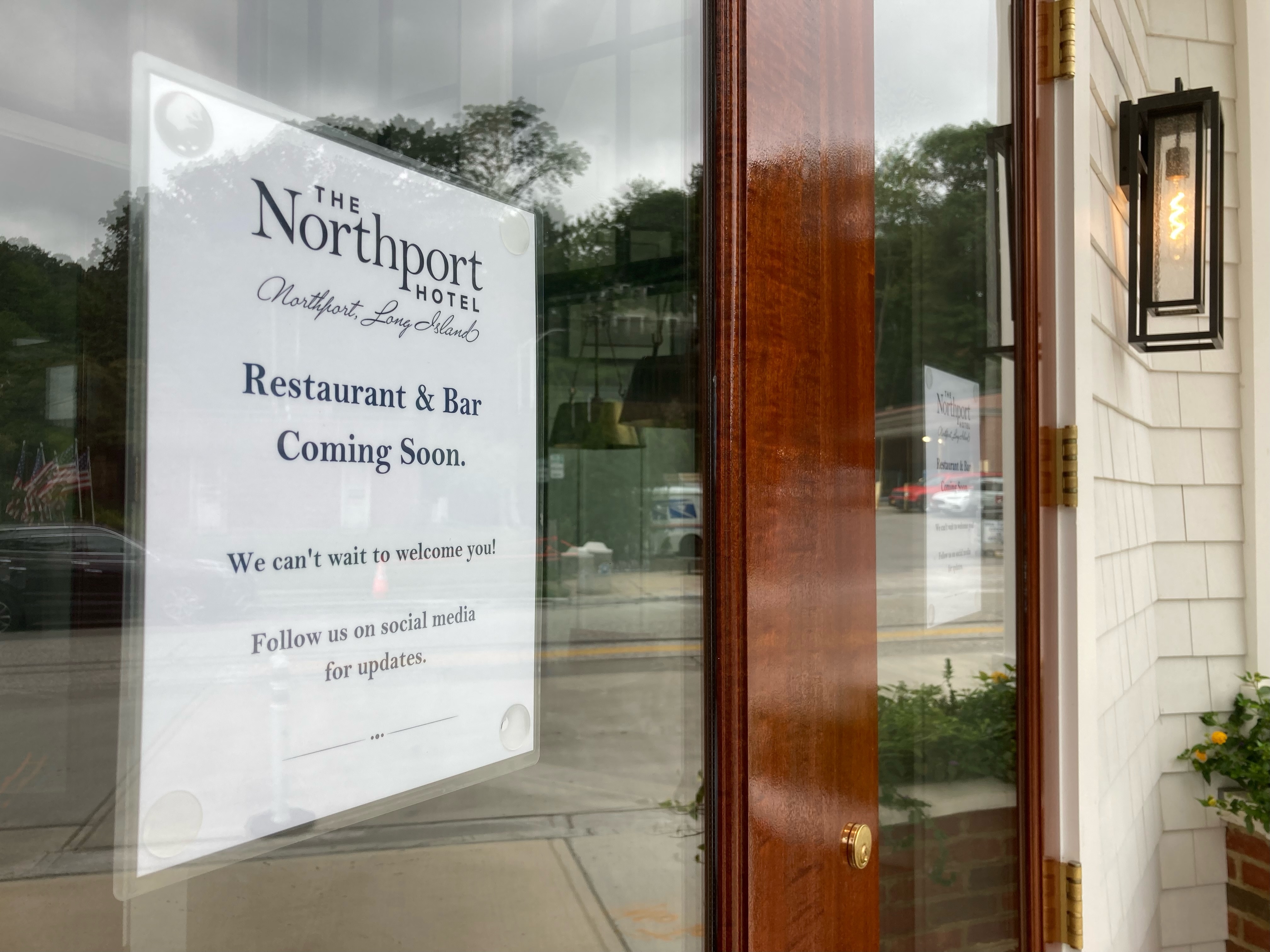 A sign on The Northport Hotel Restaurant confirms a delay in the restaurant’s opening. Originally slated to open on August 1, the restaurant will likely now open to the public and hotel guests some time in October, after ownership “retools” management and staffing.