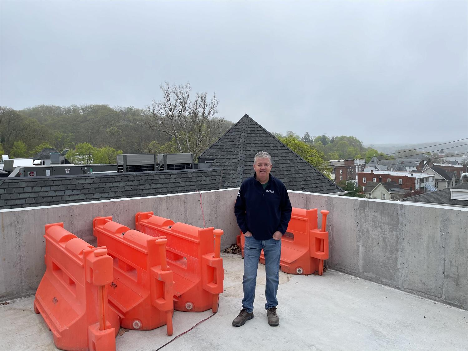 Kevin O’Neill on the upper parking deck of his 26-room luxury boutique hotel and restaurant in Northport Village.