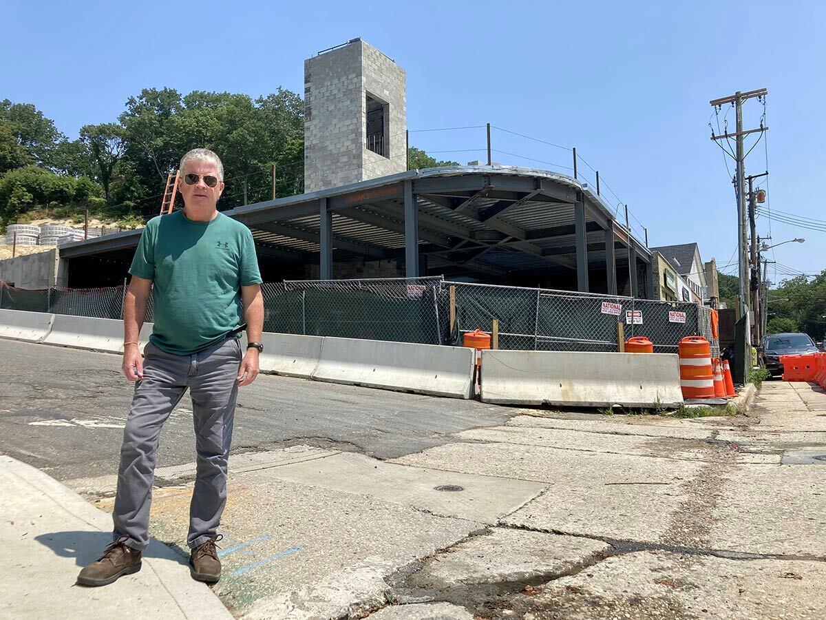 Kevin O’Neill, in front of construction of the Northport Hotel in Northport Village, is forging ahead after a judge ordered that his lawsuit against the Village can proceed.