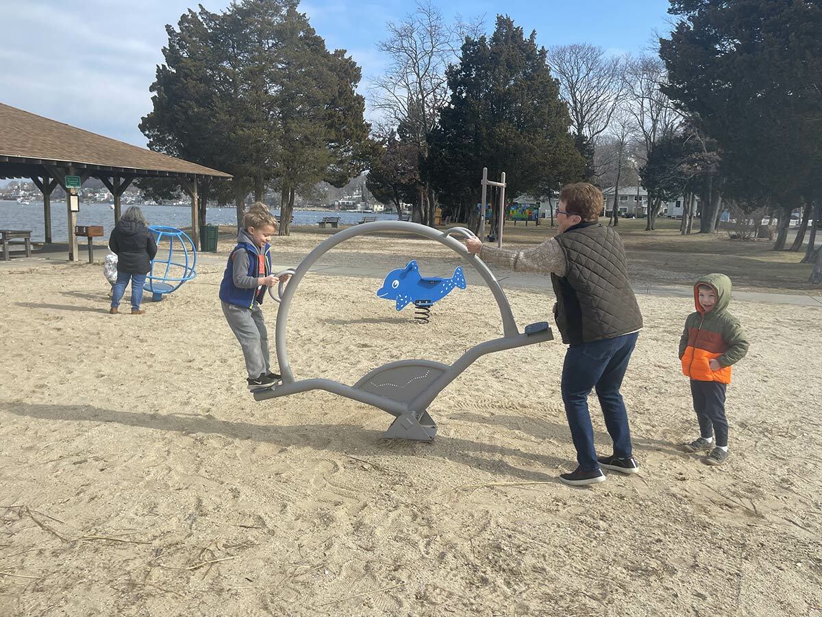 Families enjoy a new playground at Scudder Beach, unveiled by Northport Village officials this past Wednesday, March 2.