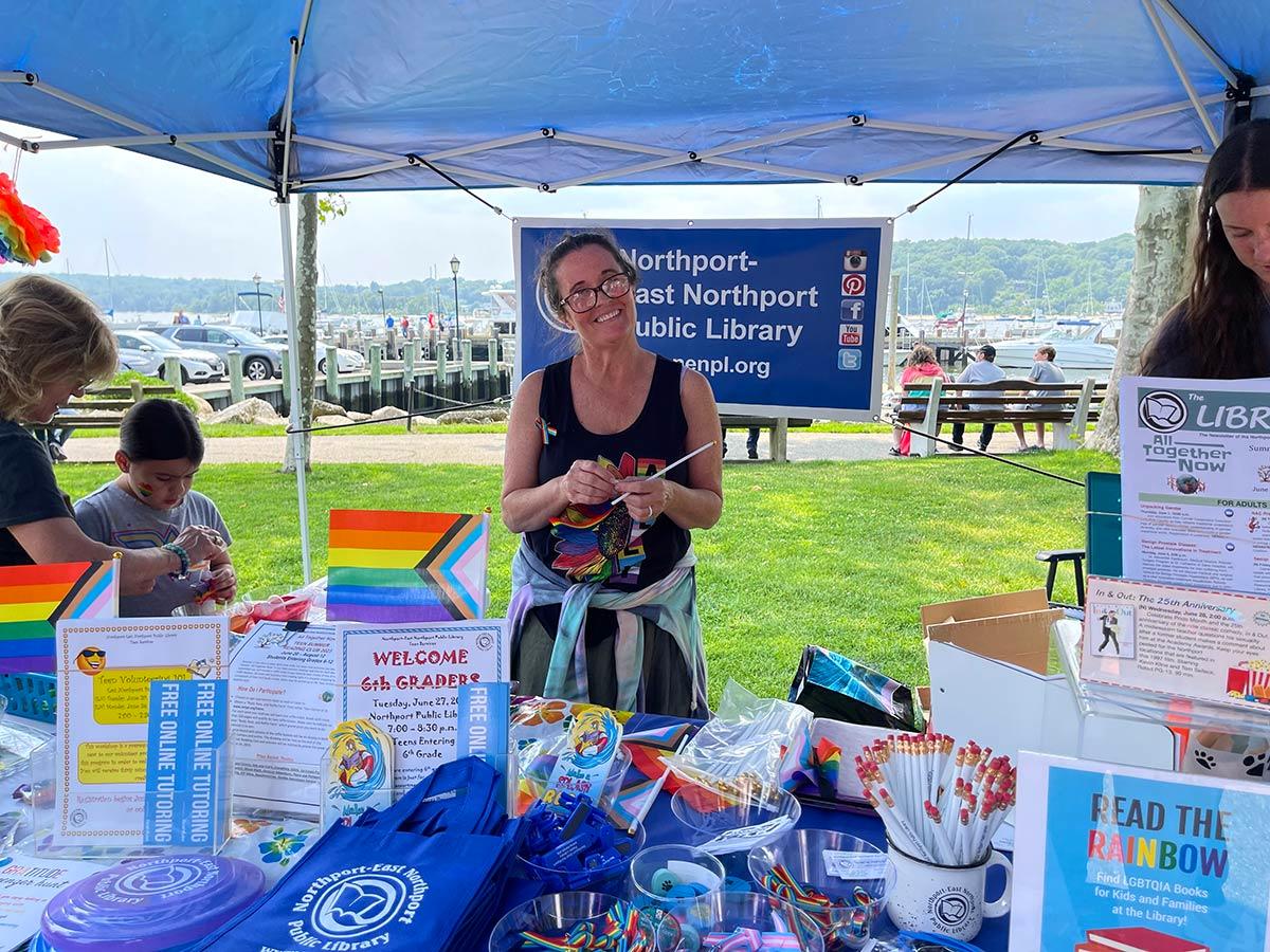 The Northport-East Northport Public Library had a table with sand art for kids and many giveaways, including Pride ribbons, frisbees and pins.