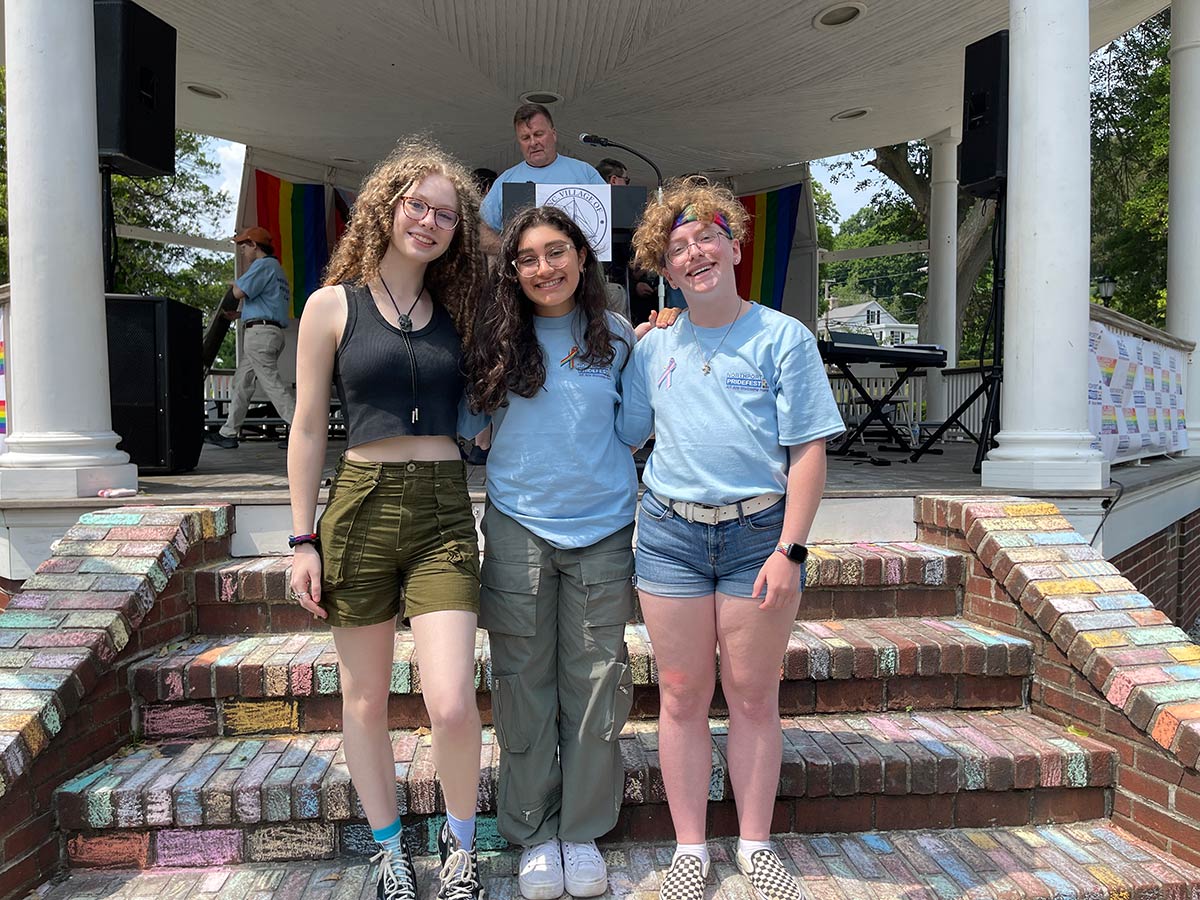 Northport High School students Sadie Callahan, Anna Tumbarello and Ethan Soda spoke at Northport Pridefest in front of hundreds of attendees, telling their personal stories and expressing their gratitude for such an event in their community. Soda said that experiencing Pride in Northport made his dream come true.