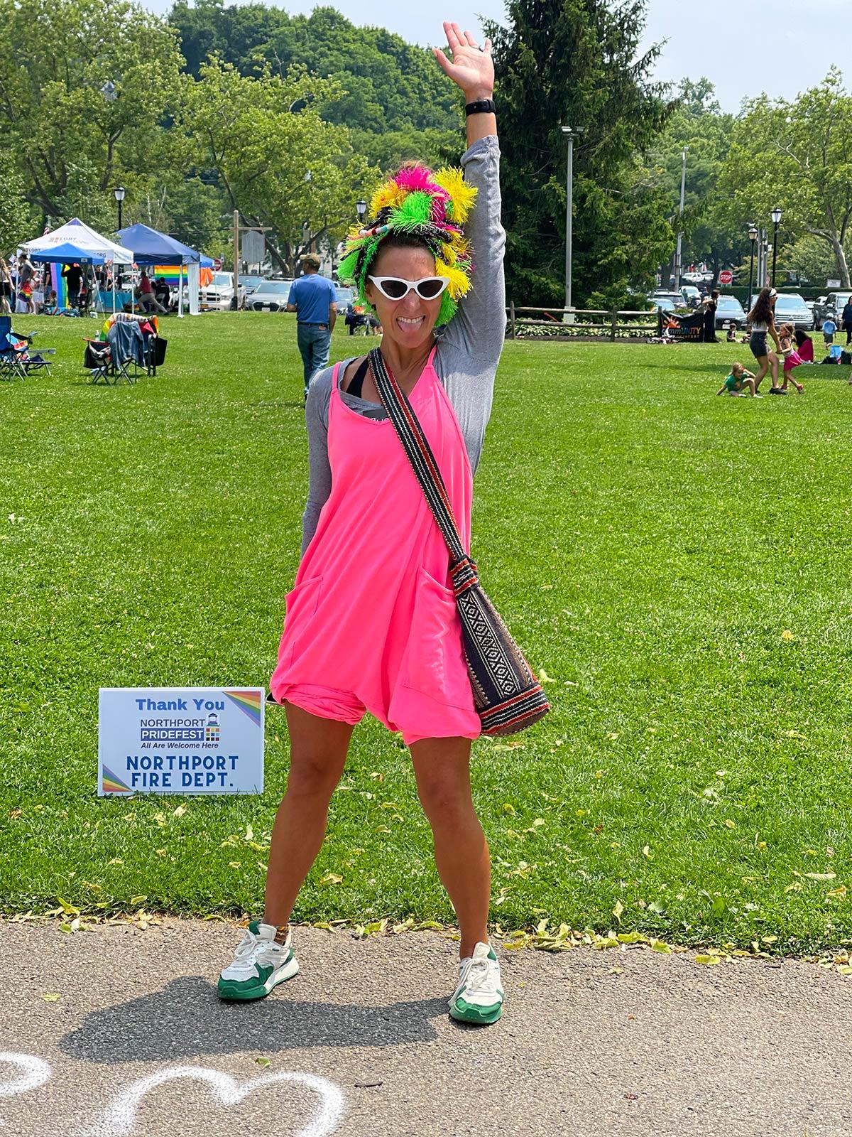 A Pridefest attendee roots on the speakers with joy and enthusiasm.
