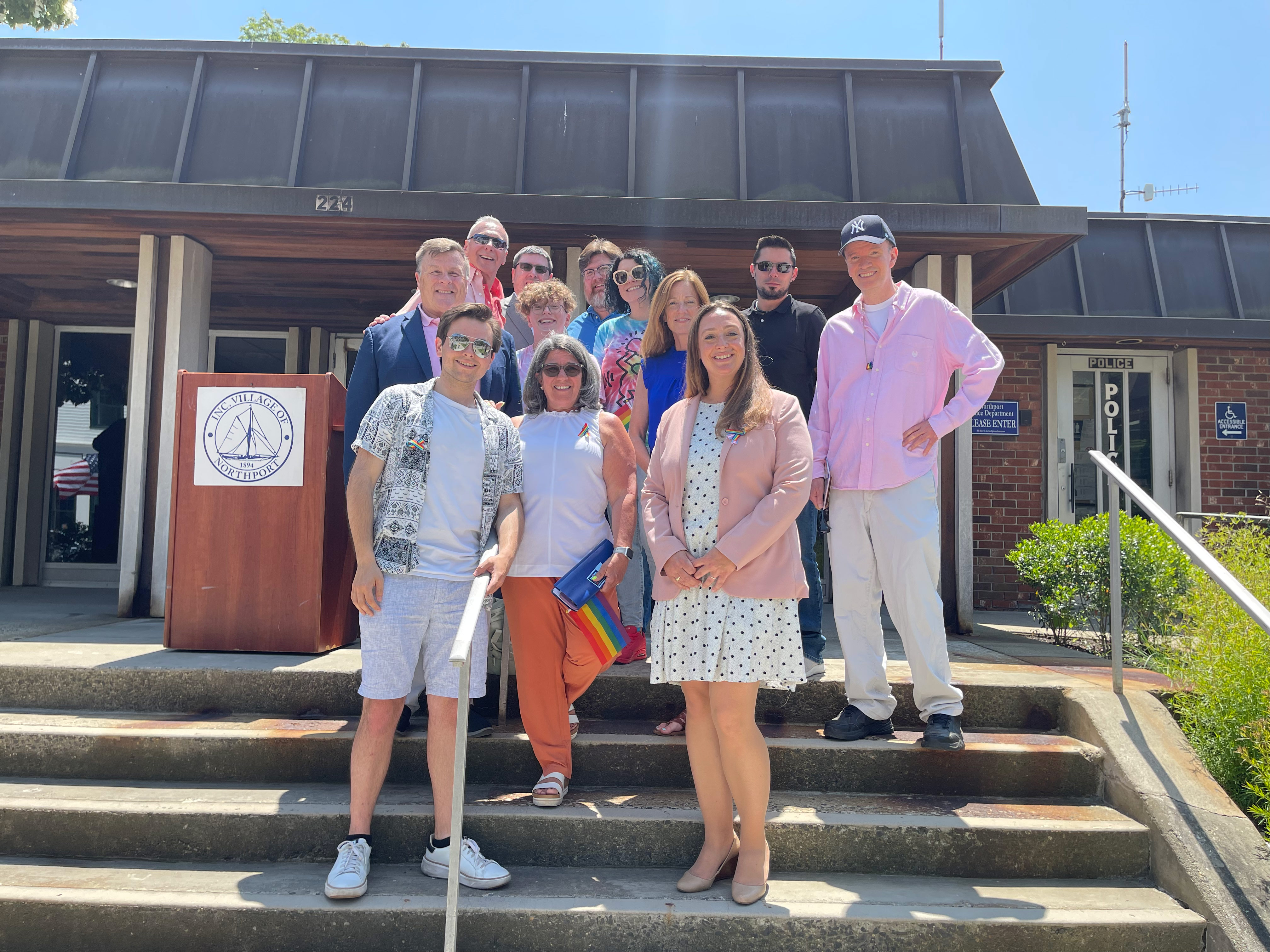 Pridefest organizers Meghan Dolan and Joe Schramm stand alongside members and supporters of the LGBTQ community. Northport Journal photo.