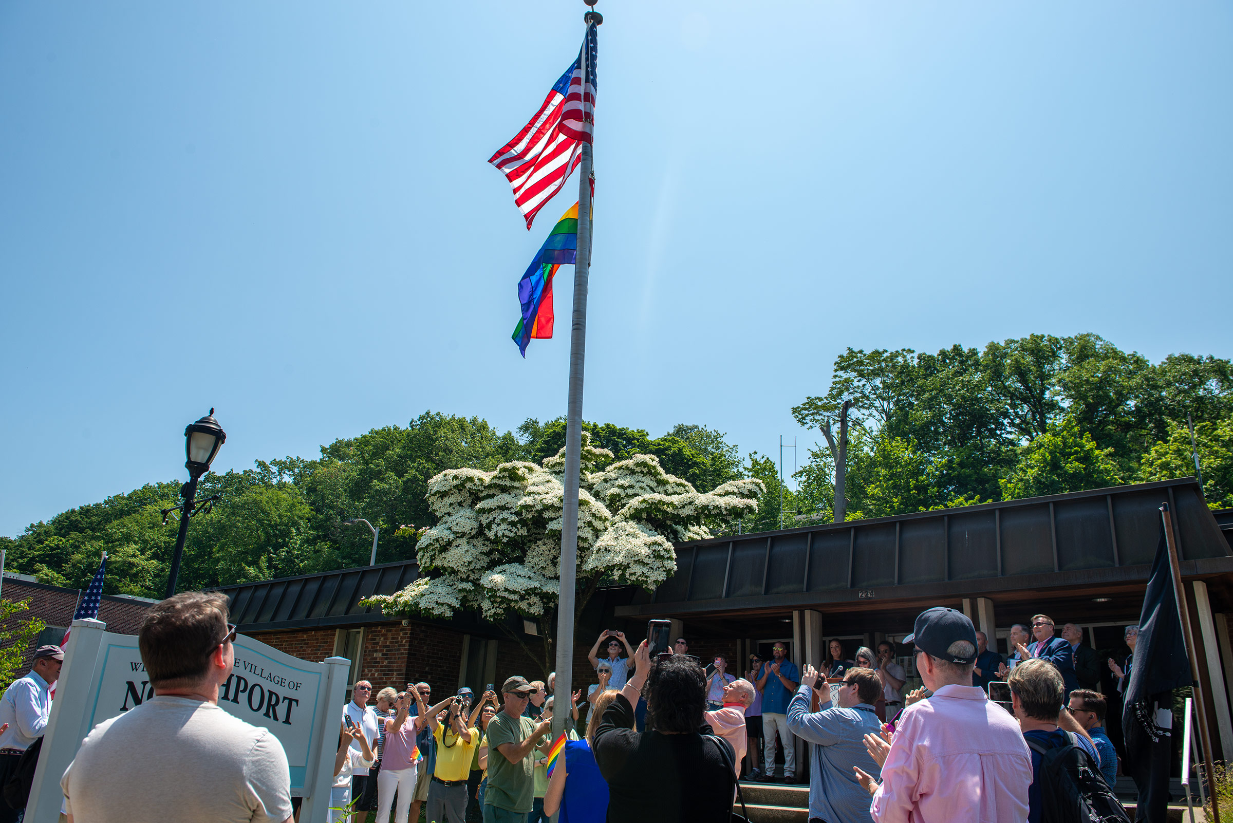 The moment the Pride flag was raised outside Village Hall. Northport Journal photo.