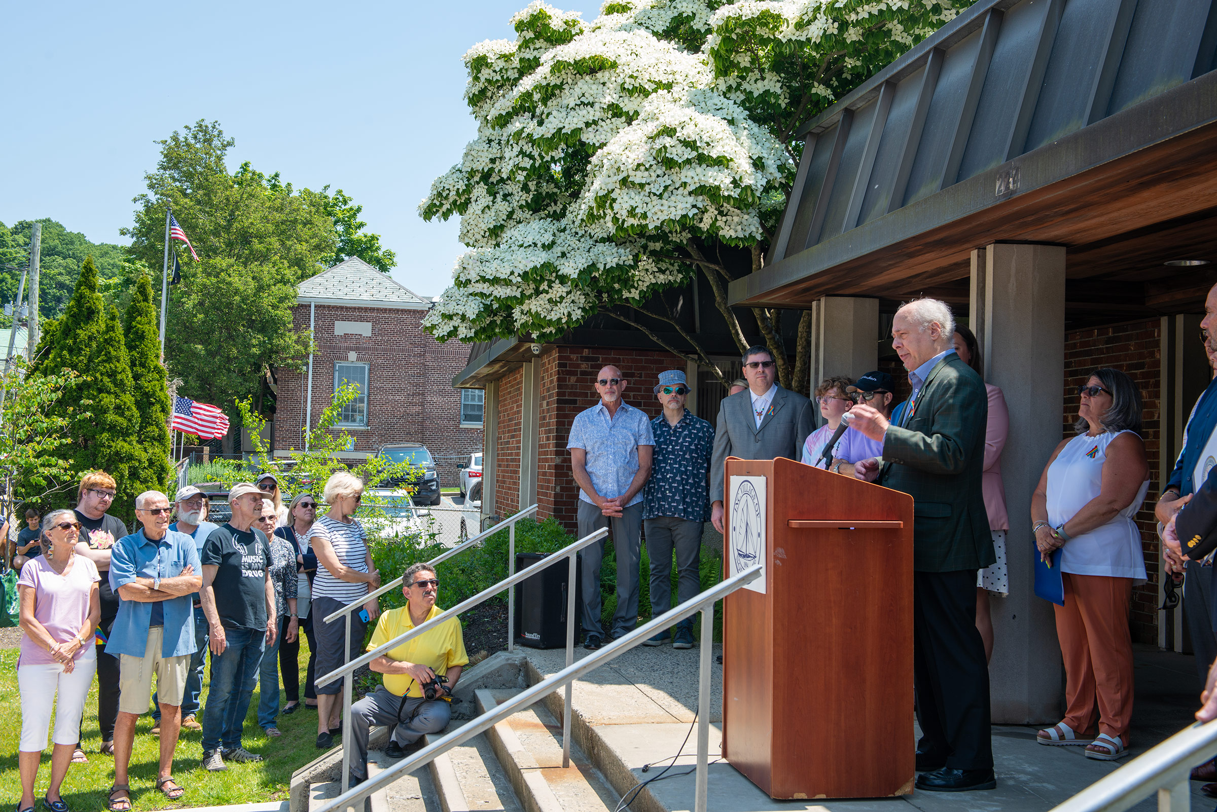 Former Village Trustee and Deputy Mayor Henry Tobin, also Northport&#39;s first openly gay elected official, speaks to the crowd. Northport Journal photo.