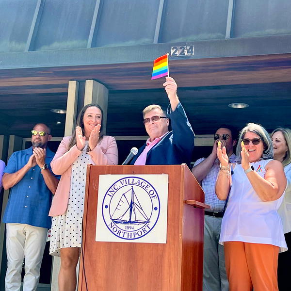 Trustee Meghan Dolan (left), Joe Schramm and Mayor Donna Koch at Northport Village&#39;s inaugural flag-raising ceremony, which again this year will kick off the community&#39;s Pride Month celebrations. 