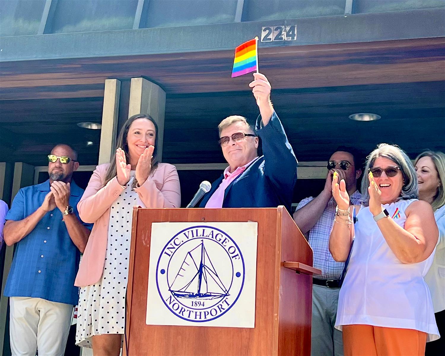 Trustee Meghan Dolan (left), Joe Schramm and Mayor Donna Koch at Northport Village&#39;s inaugural flag-raising ceremony, which again this year will kick off the community&#39;s Pride Month celebrations. 