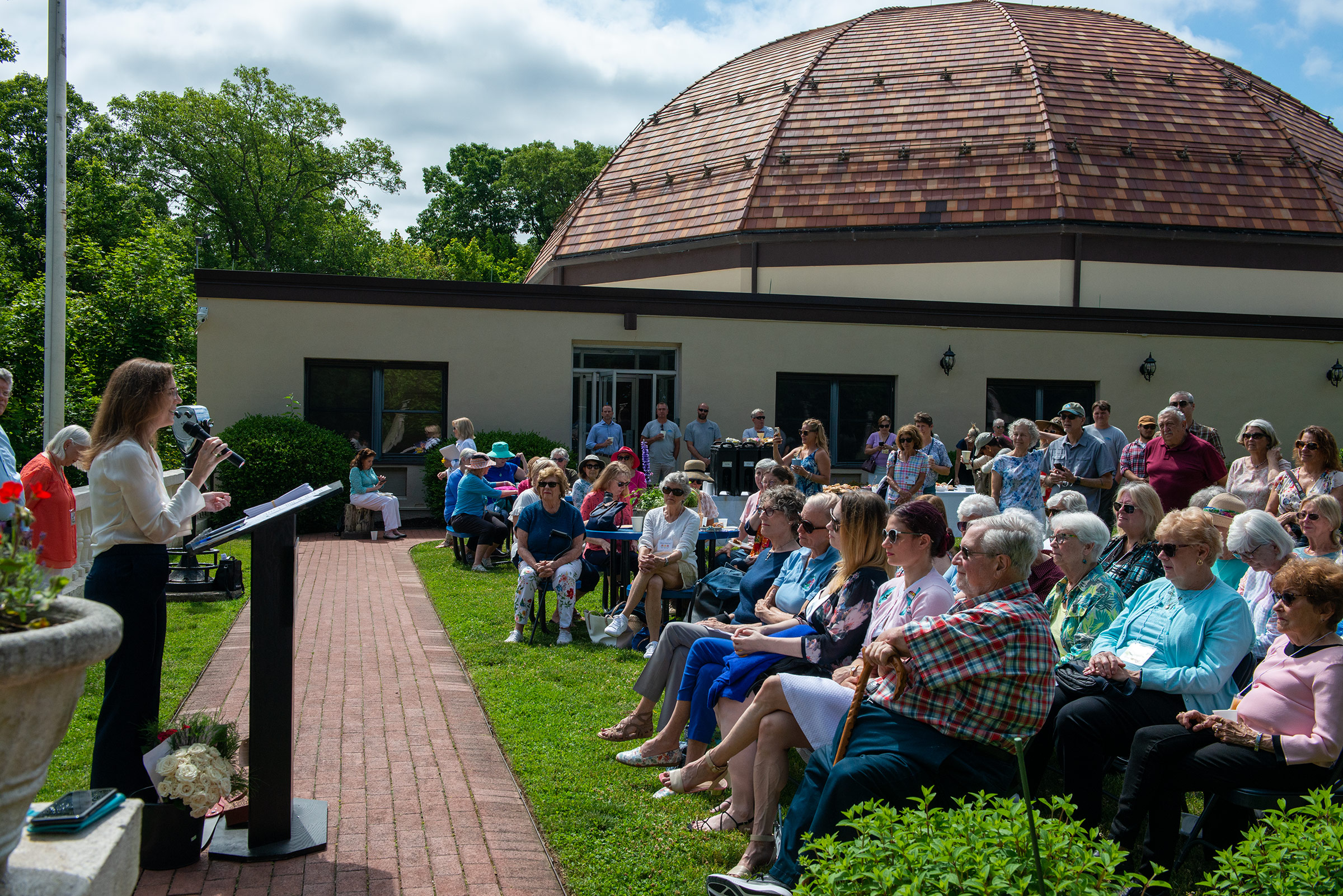 Elizabeth Wayland-Morgan, the Vanderbilt Museum’s executive director addresses the crowd of garden club members, and Vanderbilt employees integral to the success of the new rose garden.