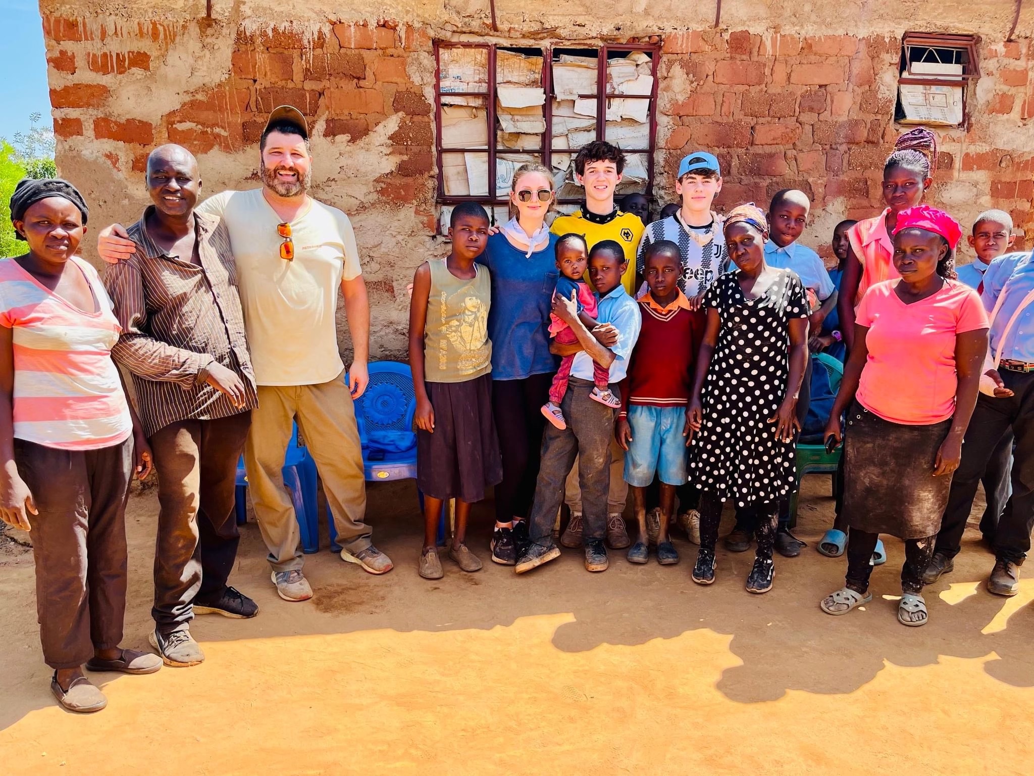 Students for 60,000 group chaperone Mike Cleary and Northport High School students with community members and children of Mtito Andei in Kenya. 