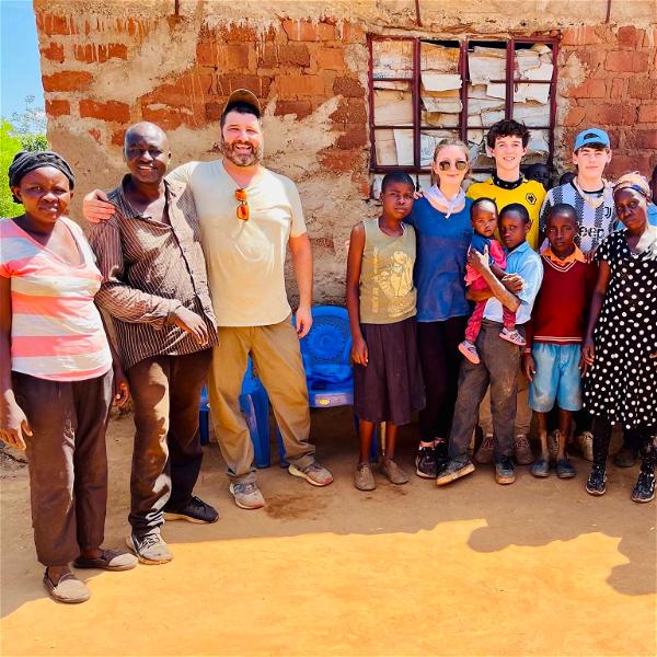 Students for 60,000 group chaperone Mike Cleary and Northport High School students with community members and children of Mtito Andei in Kenya. 