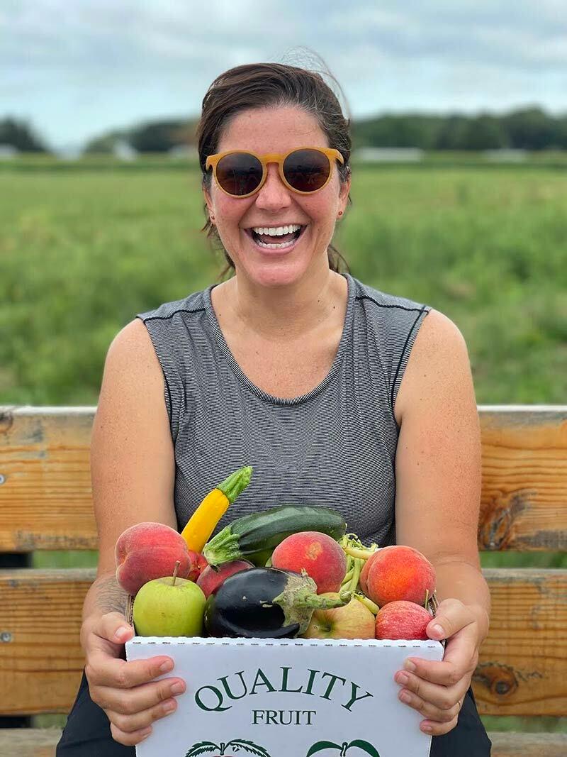 Falling for it: The Northport Journal’s own Chrissy Ruggeri enjoys a full peck of fruits and veggies at a recent trip to Windy Acres Farm in Calverton.